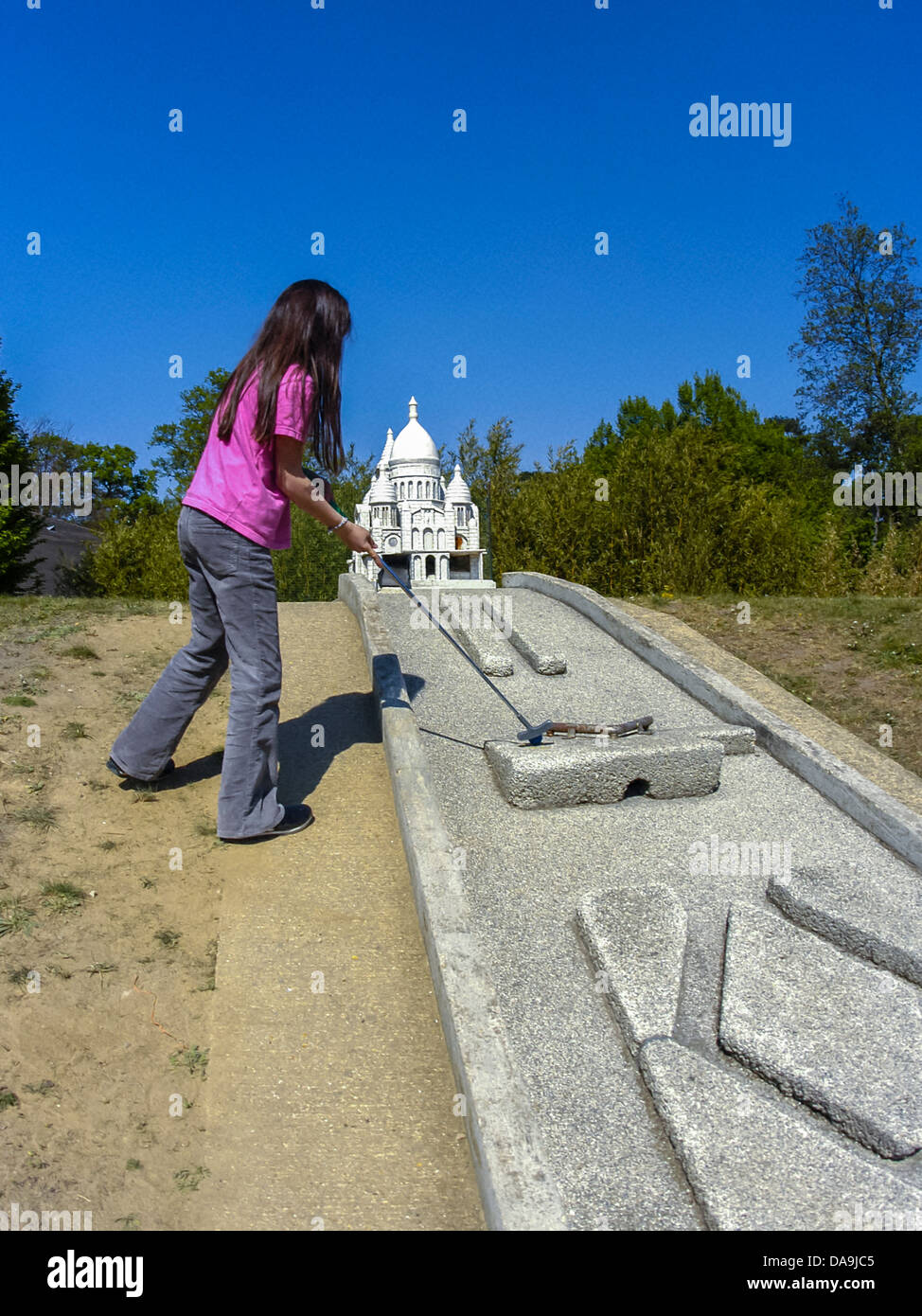 PARIS, France - Children Playing Miniature Golf Course in, Bois de Vincennes, (Model of Sacre Coeur Church). young teenage French girl, holidays fun Stock Photo
