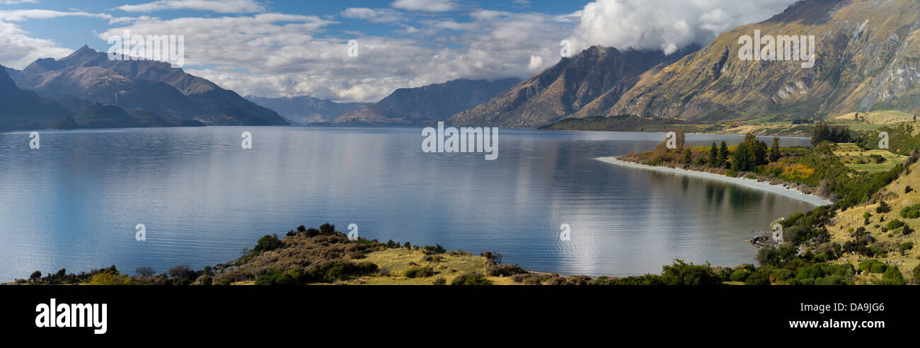 Lake Wakatipu, one of New Zealand's most beautiful lakes, surrounded by mountains and set off by clouds and blue sky. Stock Photo