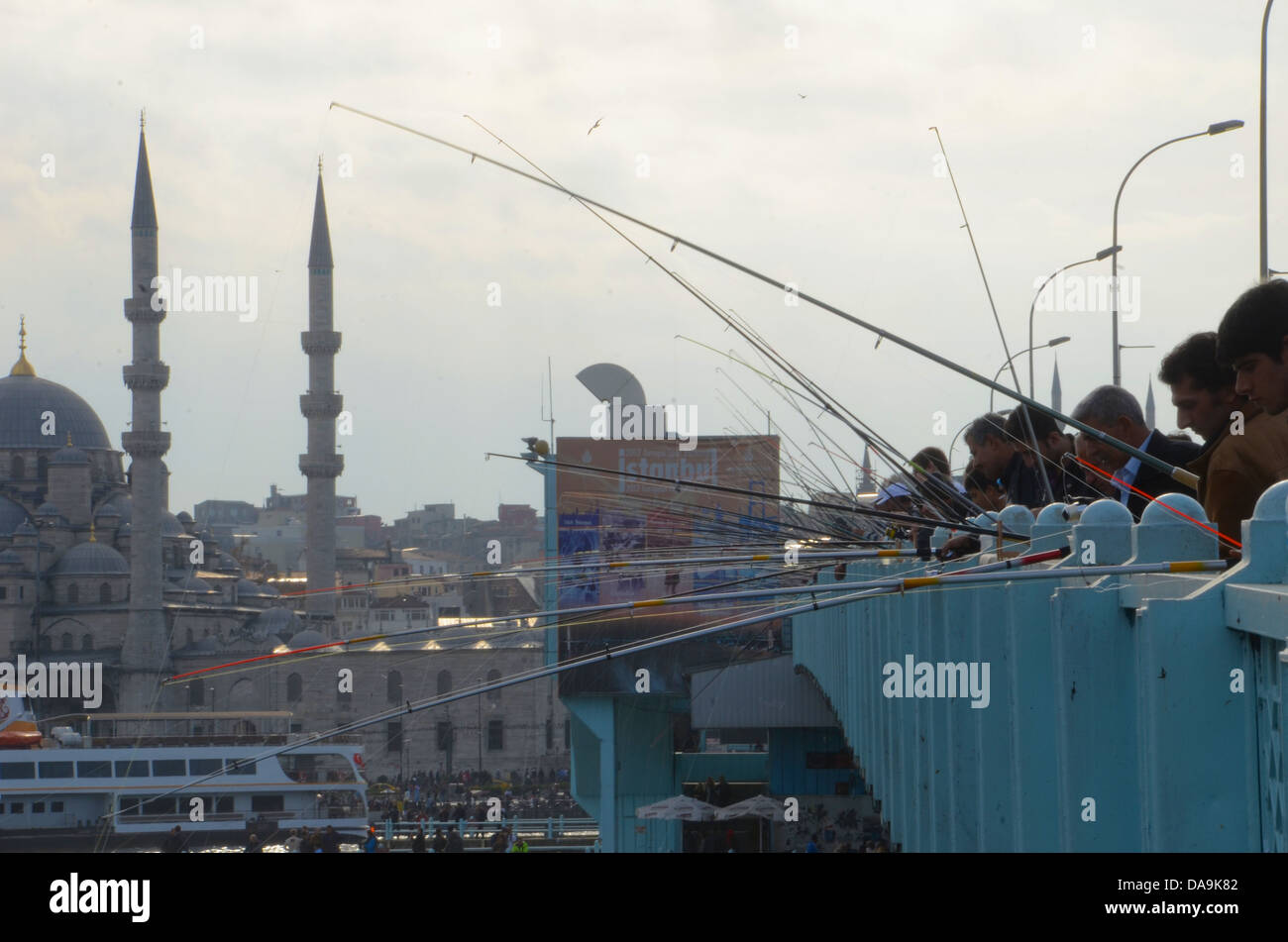 Galata Kpr., Istanbul, Turkey. Men, boys and girls fishing from this bridge on the Haliç Hattı river Stock Photo