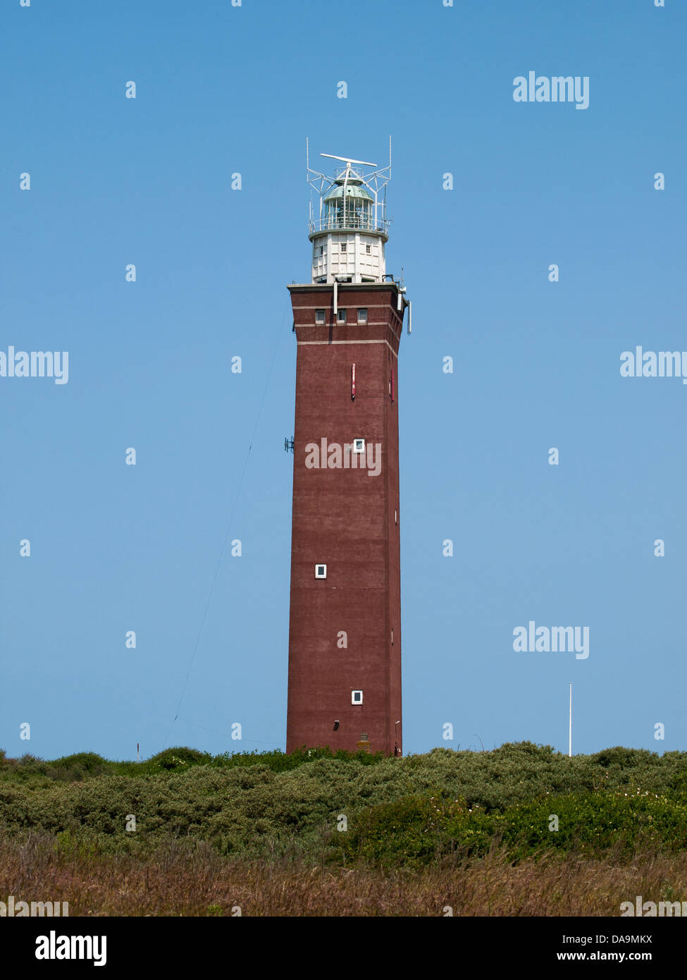 Lighthouse In The Dunes With A Blue Sky Stock Photo - Alamy