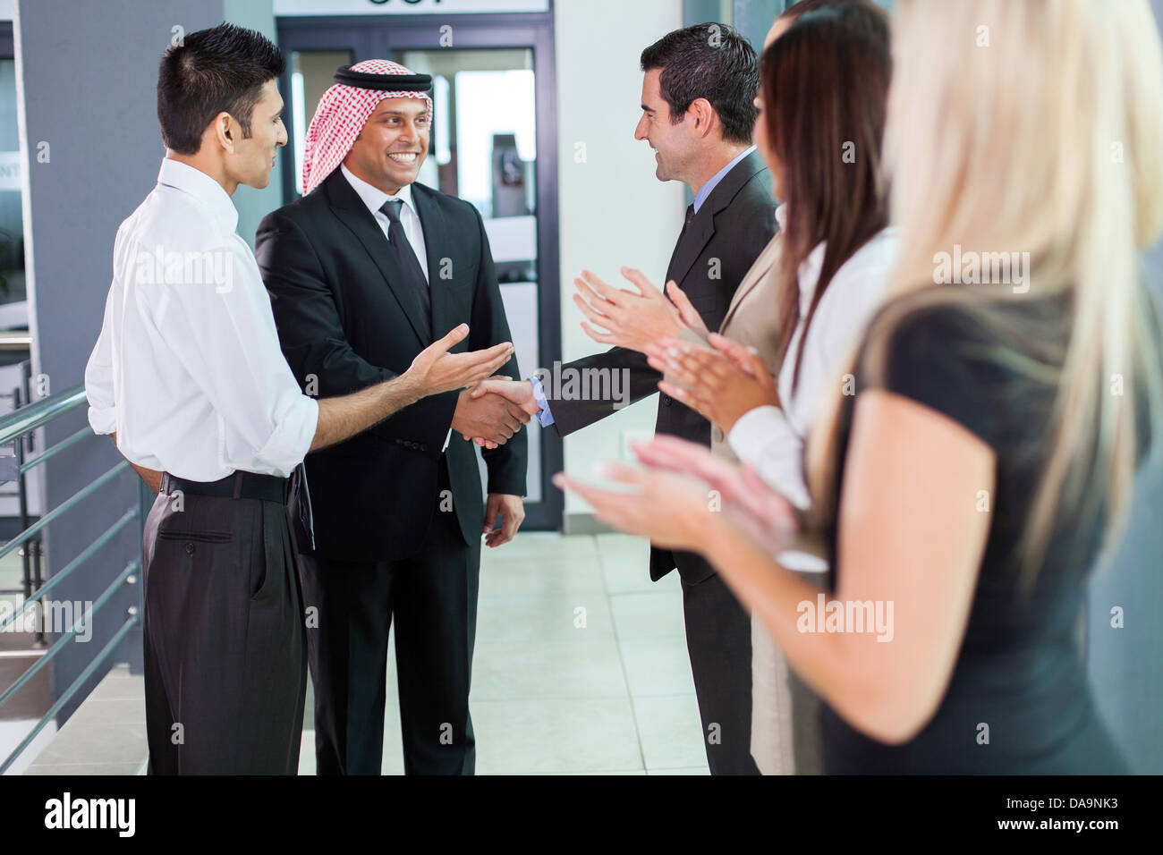 translator introducing Arabian businessman to business partners Stock Photo