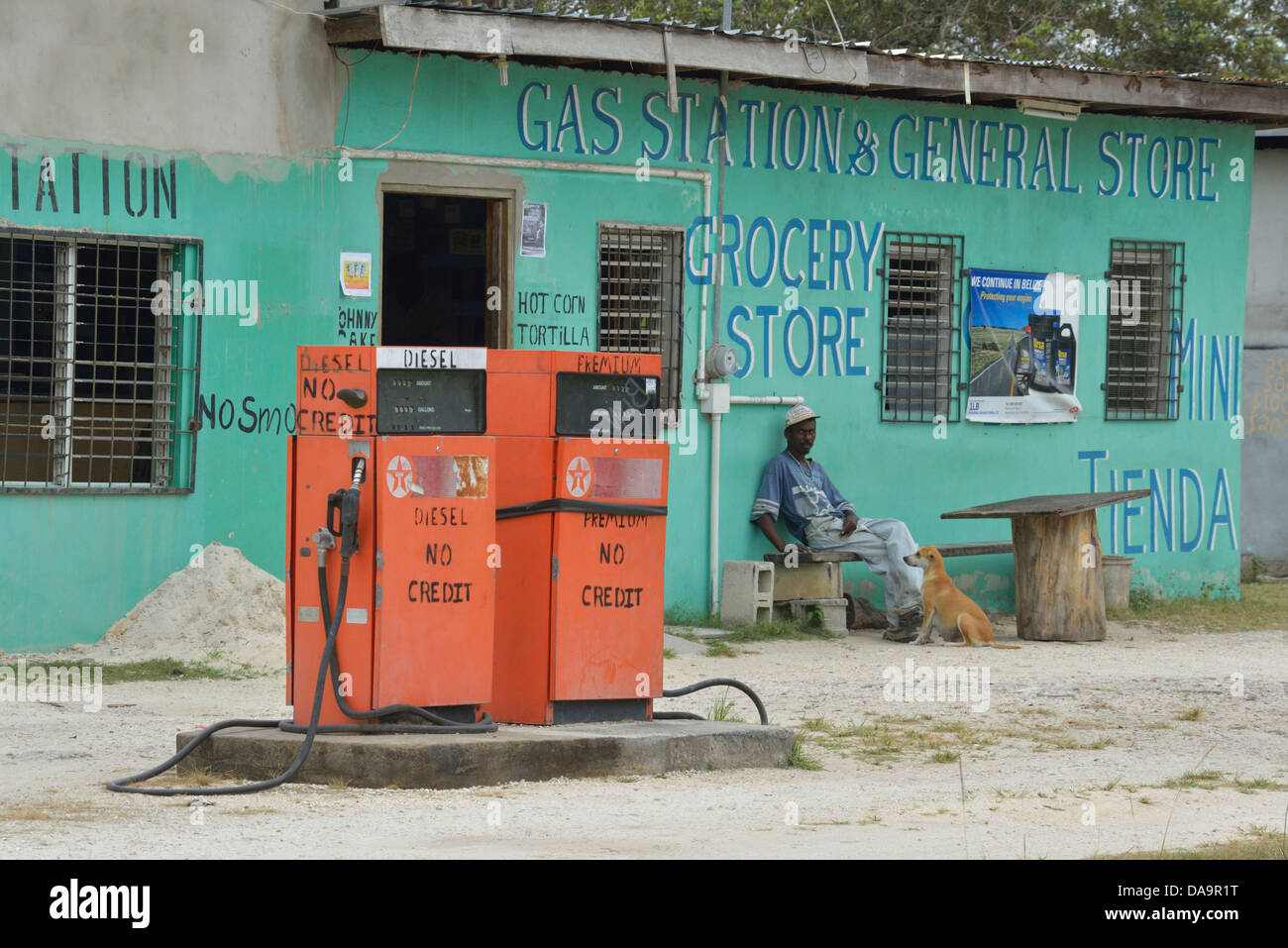 Belize City, Central America, Belize, Burrel Boom, village, gas station, man, dog, poverty Stock Photo