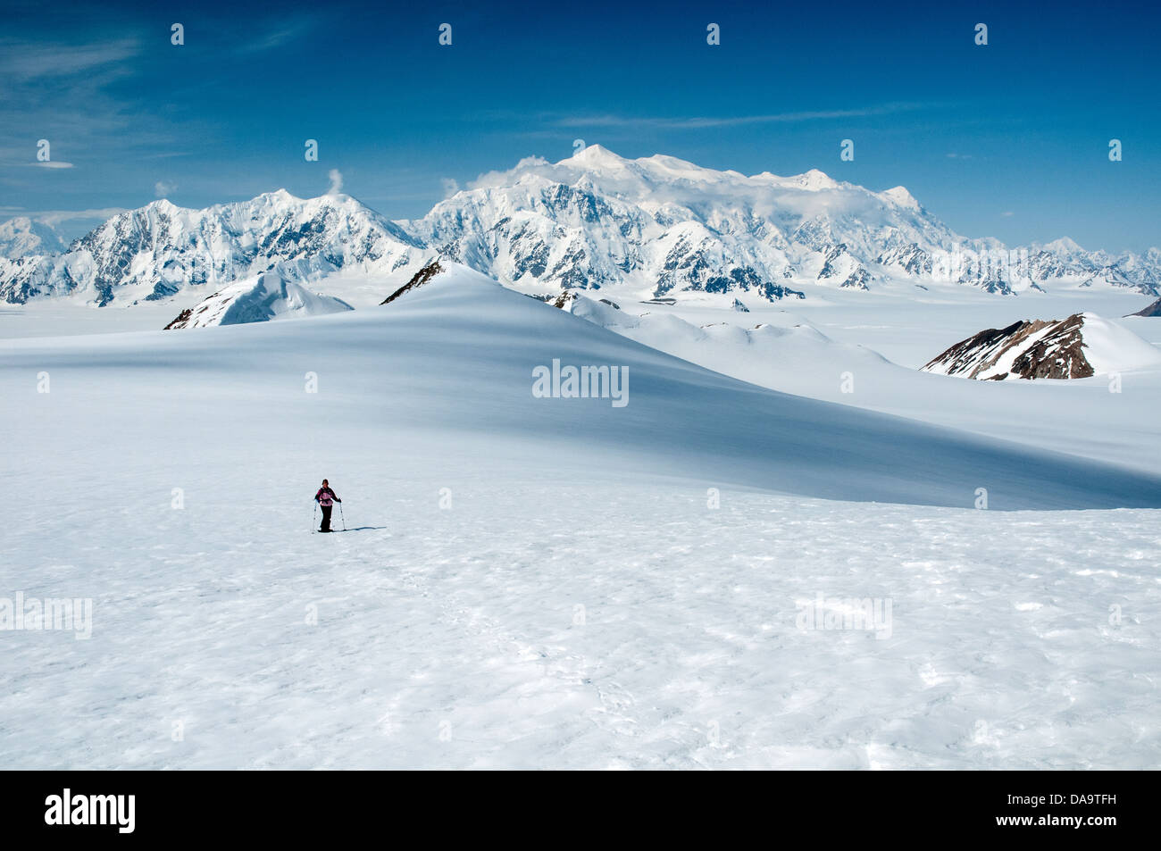 A snowshoer treks through Yukon's St. Elias Mountains, with Mount Logan