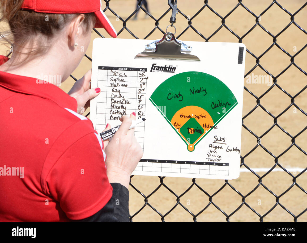 Softball coach works on her roster for the game Stock Photo
