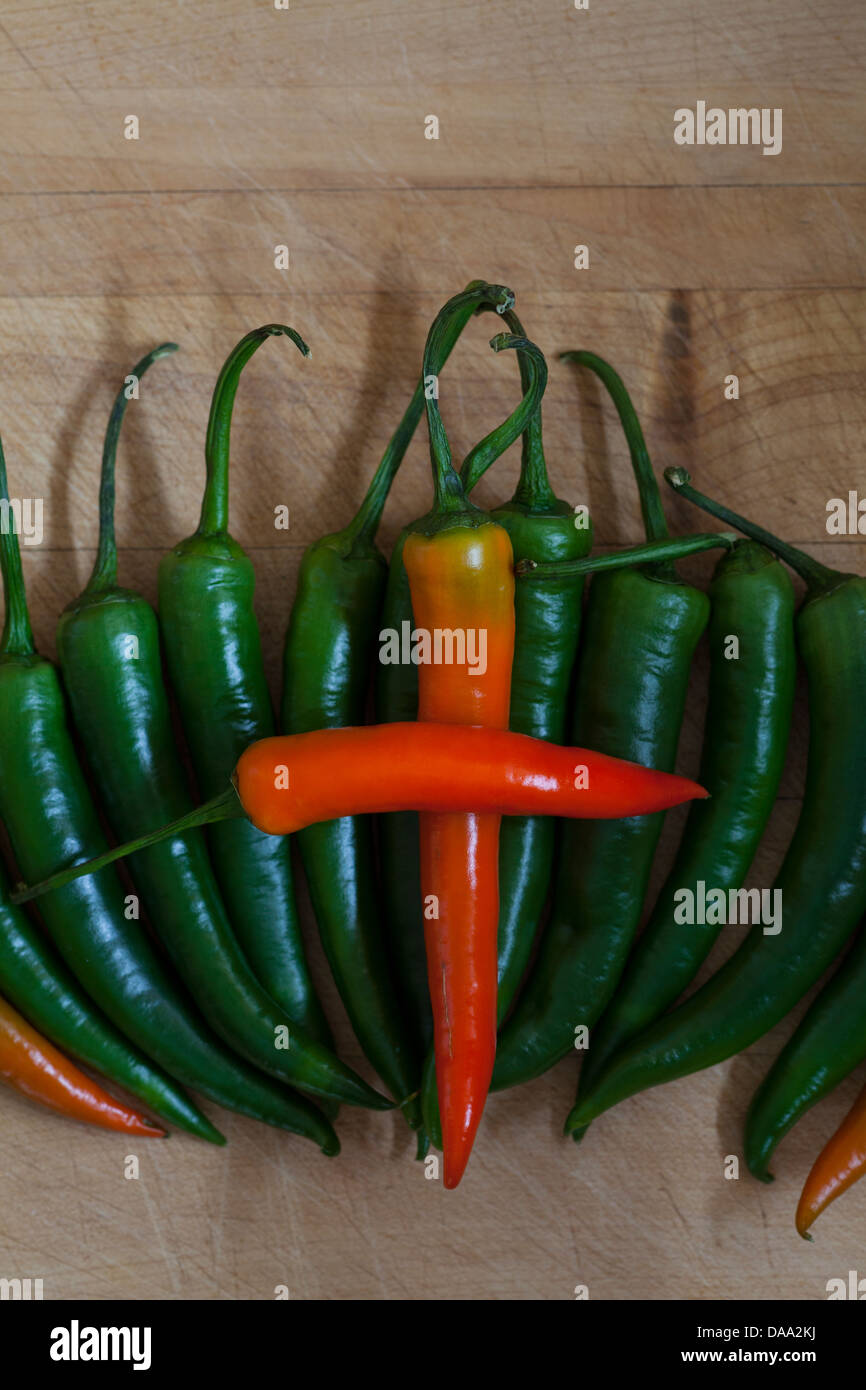 Red hot chillies peppers on a chopping board Stock Photo - Alamy