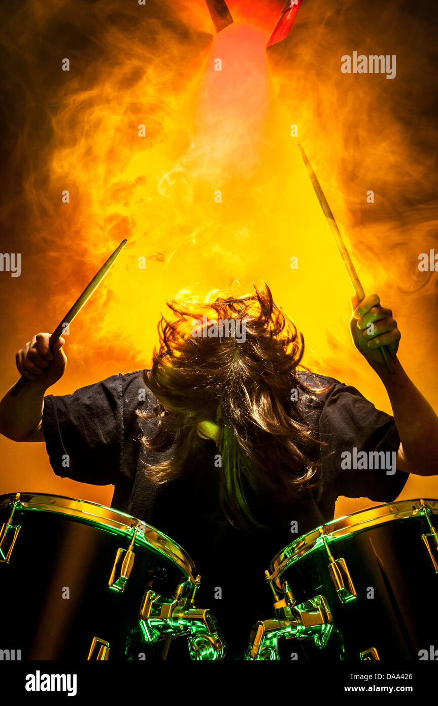 Unidentifiable young caucasian playing drums on stage. Stock Photo
