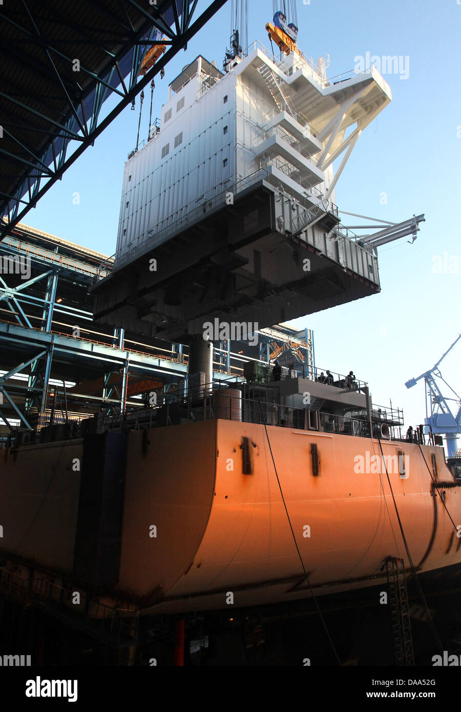 The 600tons deckhouse of a new container ship is lifted onto its place
