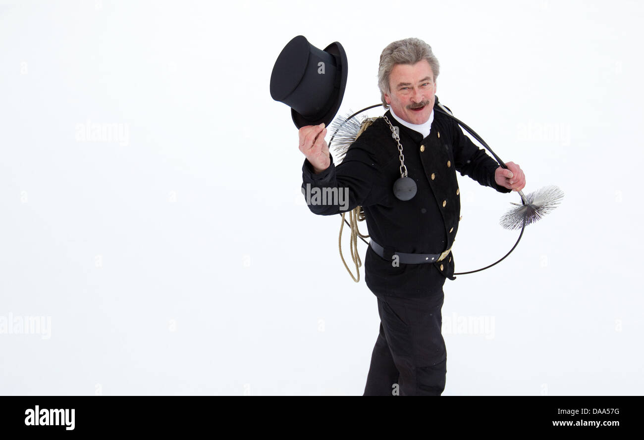 Chimney sweep Guenther Gaux presents his classic work uniform on a roof