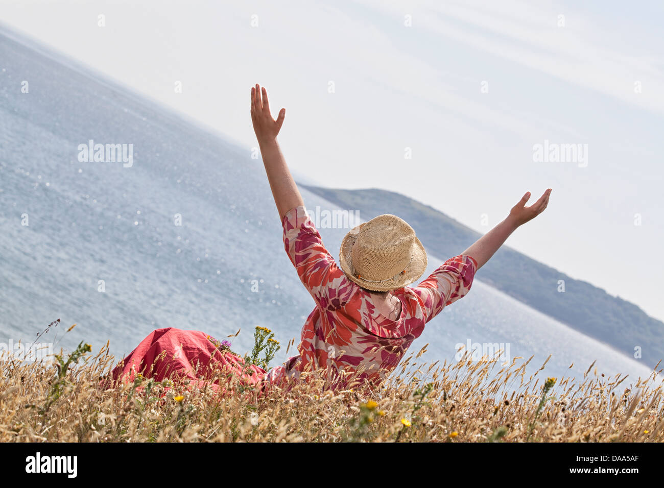 Woman with hands raised toward heaven Stock Photo