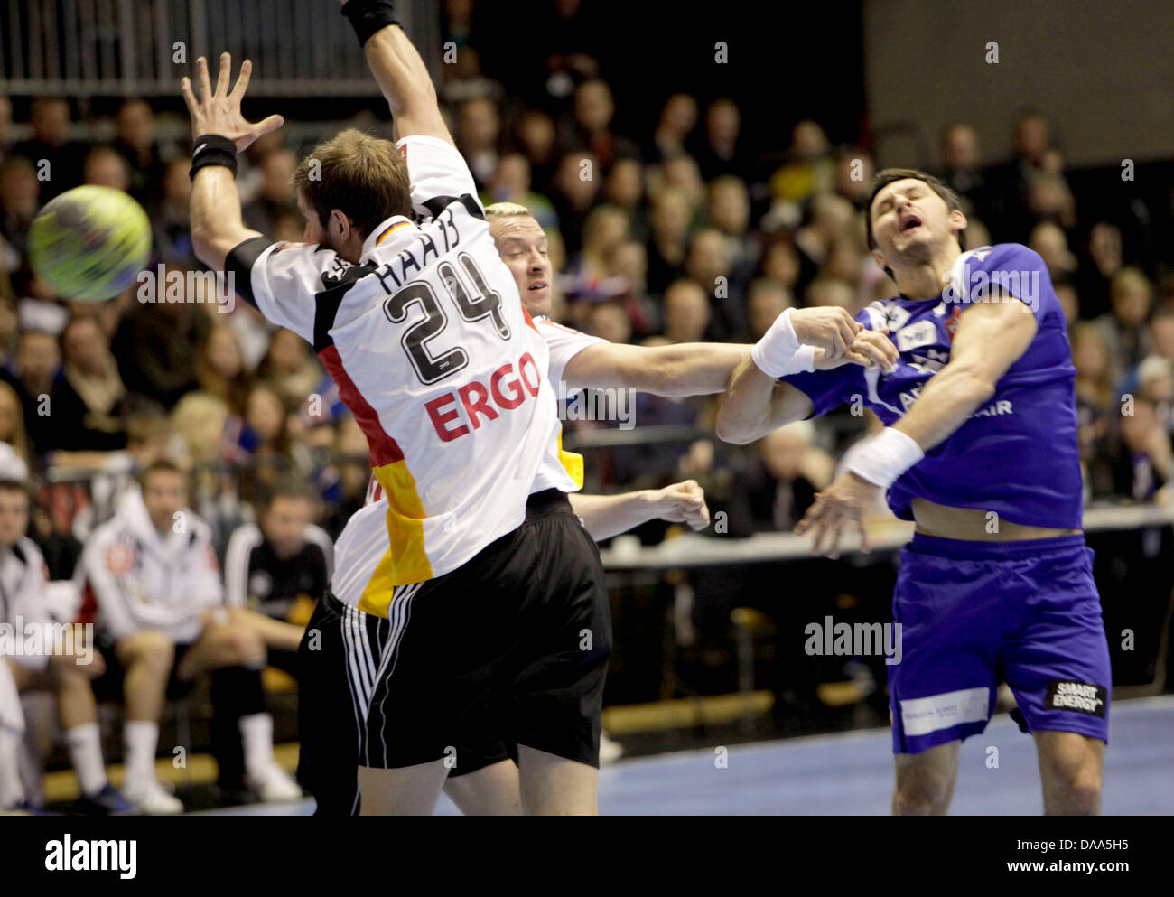 Germany's Michael Haass (l) and Pascal Hens  tackle Iceland's Alexander Peterson (r) during a handball match of Germany versus Iceland in Reykjavik, Iceland, 8 January 2011. Photo: Halldor Kolbeins Stock Photo