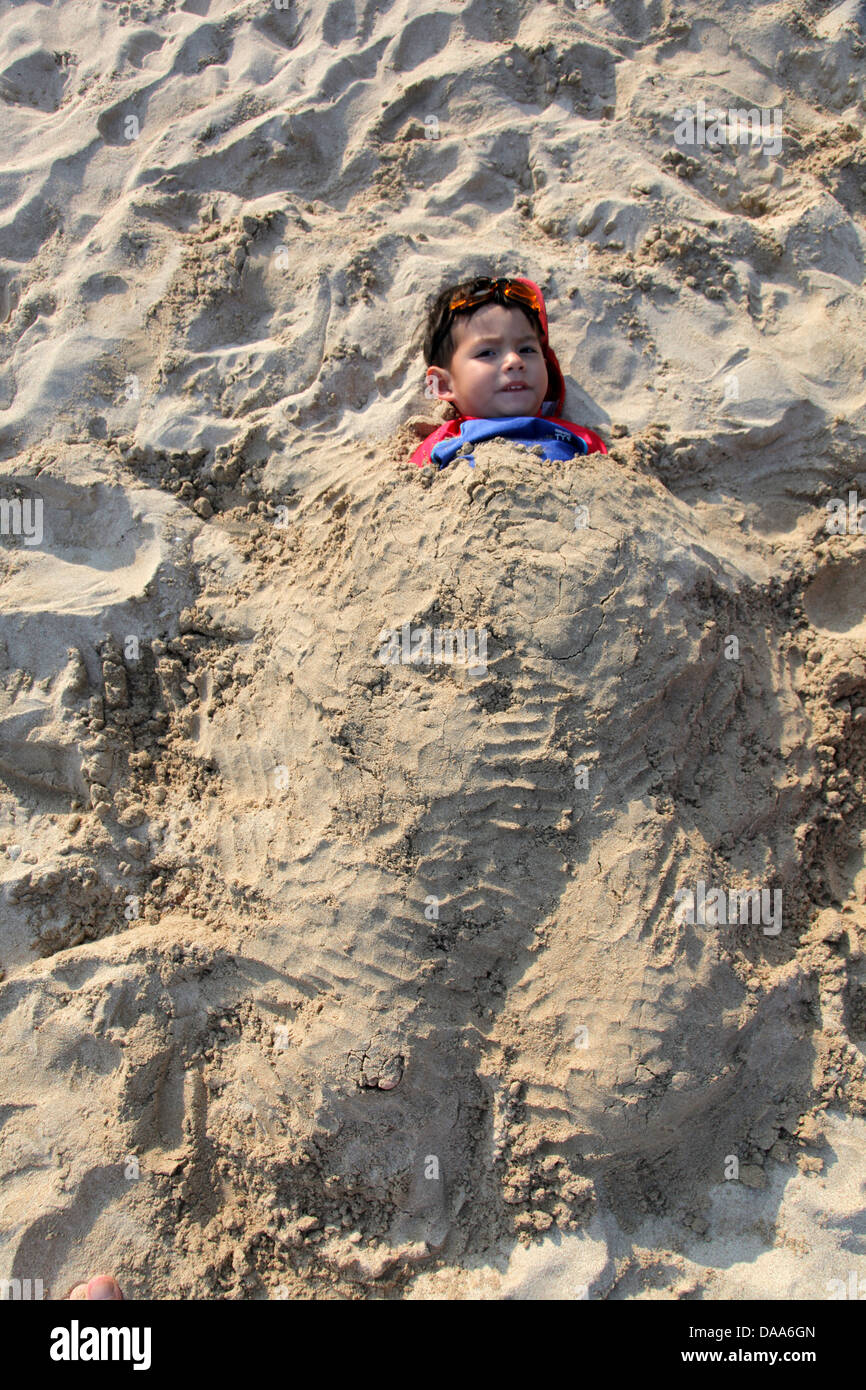 Cover boy in sand at beach hires stock photography and images Alamy
