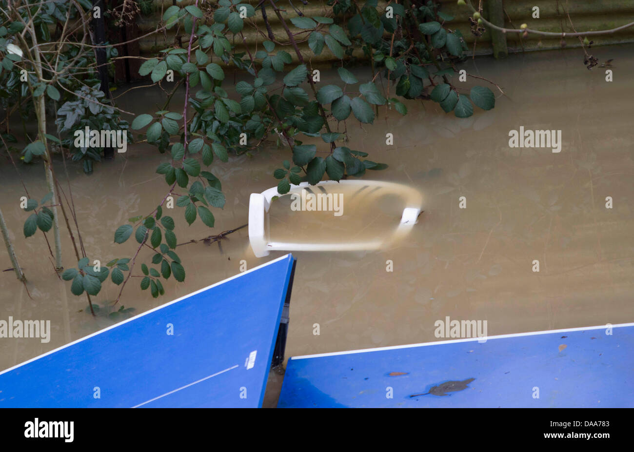A Ping Pong Table And A Chair Are Flooded By The River Main