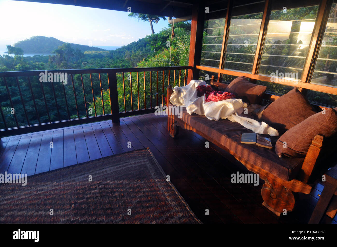 Daybed on verandah of house overlooking Cape Tribulation and the Great Barrier Reef, Daintree National Park, Australia Stock Photo