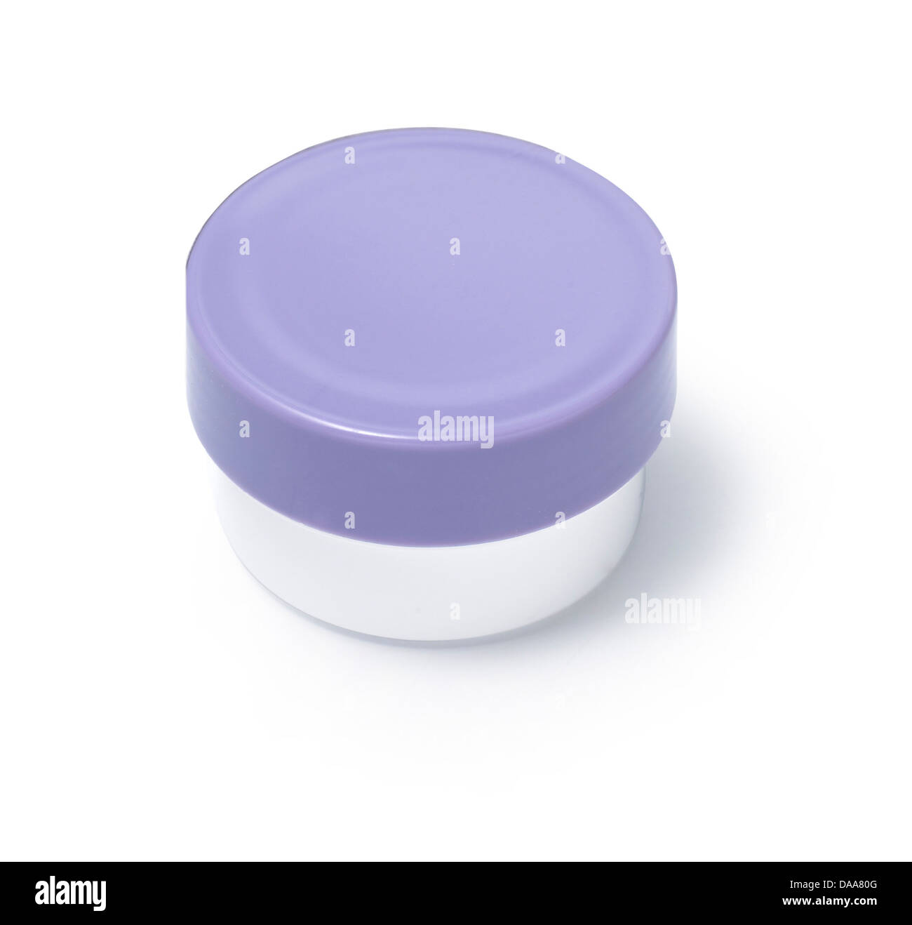 cosmetic pot with purple lid cut out onto a white background Stock Photo