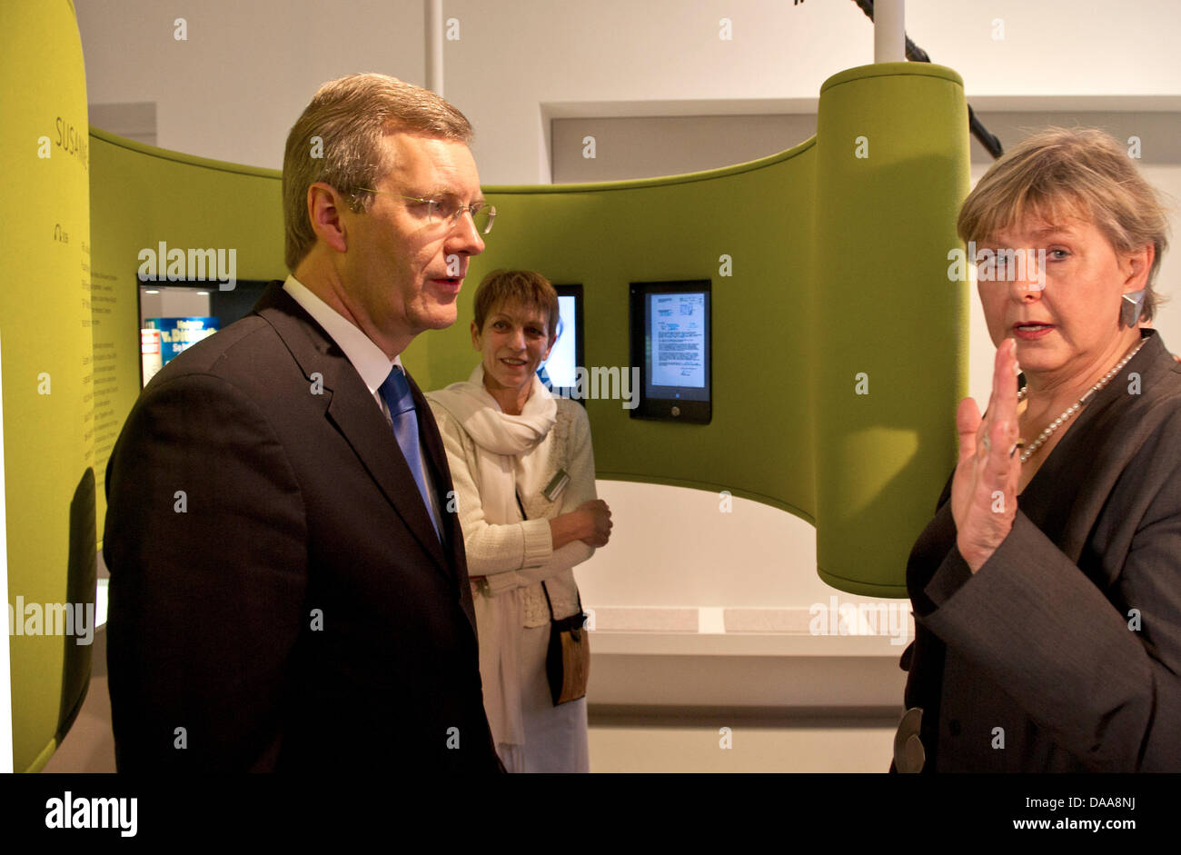 German Federal President Christian Wulff (L) and the Federal Commissioner for the Stasi Archives Marianne Birthler (R) speak with each other at the opening of the permanent exhibition about the Stasi in Berlin, Germany, 15 January 2011. In an area over 260 square meters, visitors to the educational exhibition can learn about the history of the Stasi and how it tried to penetrate in Stock Photo