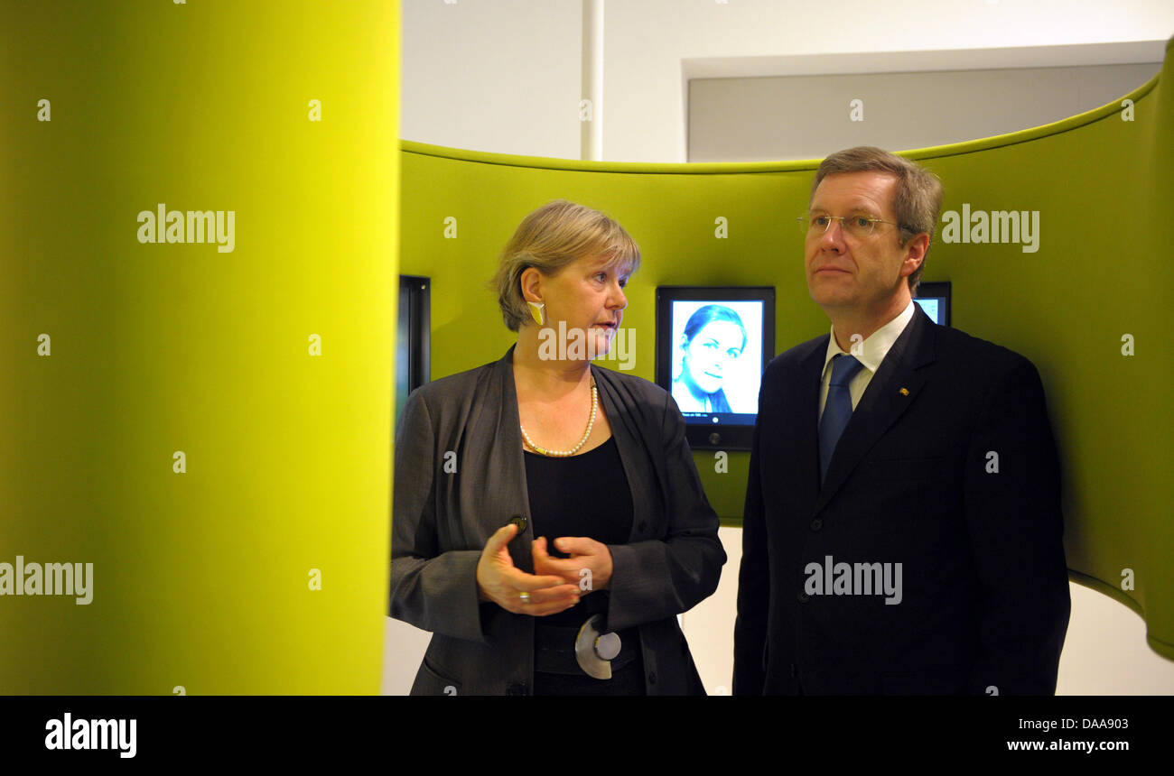 German Federal President Christian Wulff (R) and the Federal Commissioner for the Stasi Archives Marianne Birthler (L) speak with each other at the opening of the permanent exhibition about the Stasi in Berlin, Germany, 15 January 2011. In an area over 260 square meters, visitors to the educational exhibition can learn about the history of the Stasi and how it tried to penetrate in Stock Photo