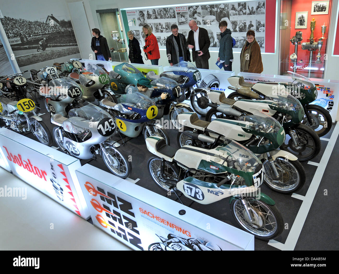 Visitors to the motorcycle museum eye a row of MZ motorcycles in Augustusburg, Germany, 18 January 2011. The museum presents a total of 175 motorcycles, which is Europe's biggest collection. Photo: Hendrik Schmidt Stock Photo