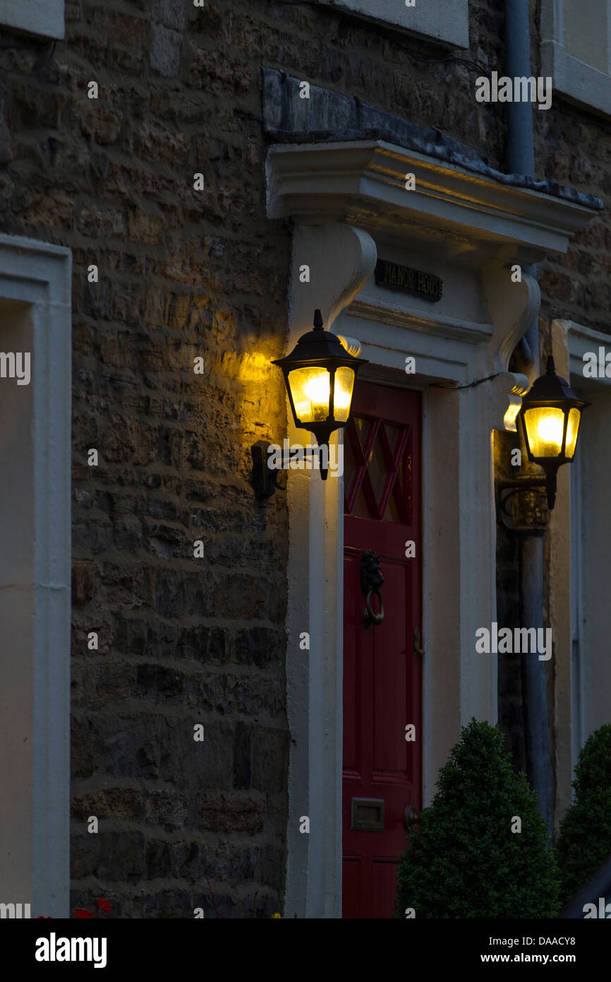 Old lamps lite up at dusk in Askrigg, North Yorkshire Stock Photo