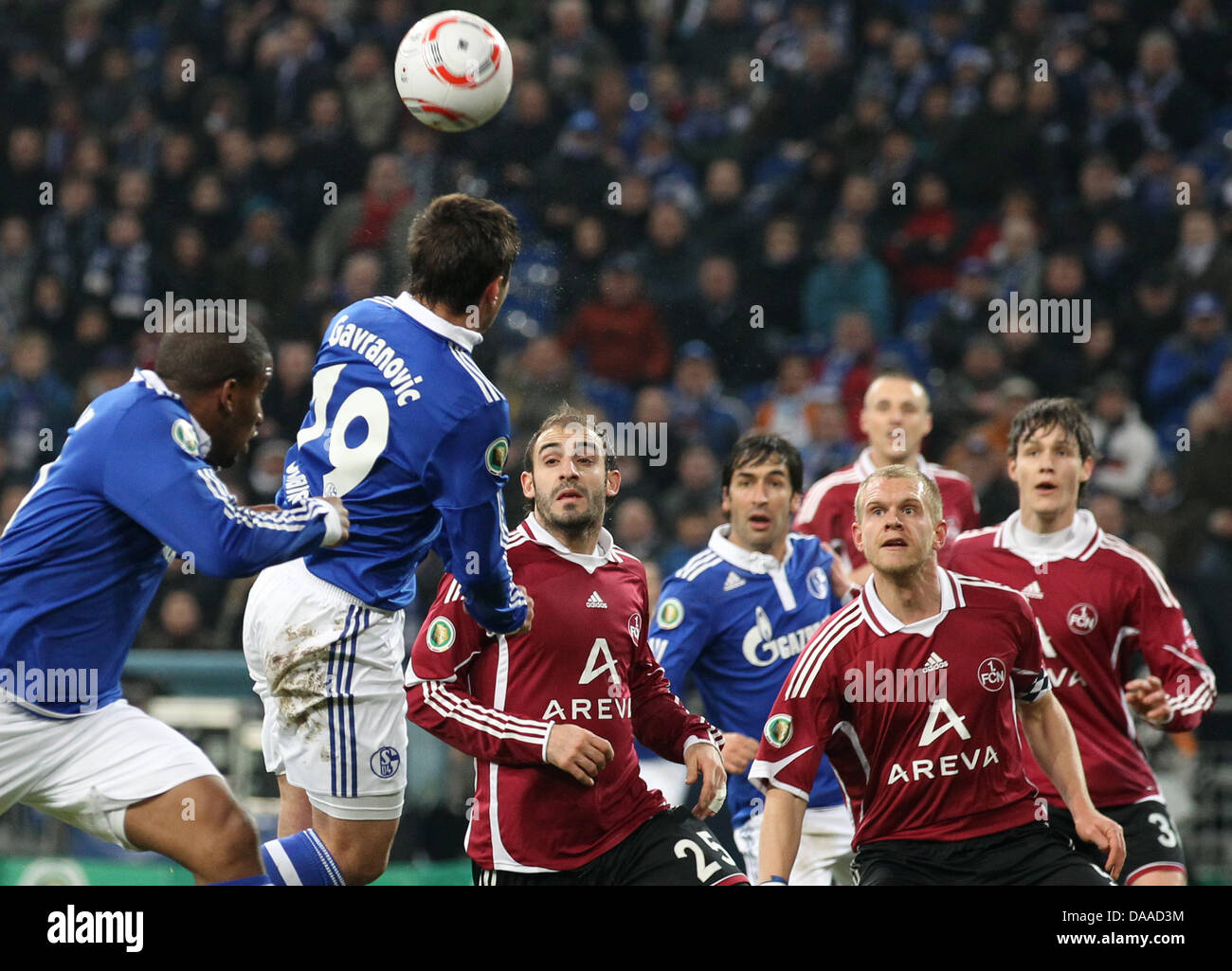DFB-Cup Soccer Quarter-Finale: FC Schalke 04 versus 1.FC. Nürnberg on 25 January 2011 at the Veltins-Arena in Gelsenkirchen, Germany. The Schalke player Mario Gavranovic (2nd from left) fighting for the ball with Nürnberg players Horacio Javier Pinola (middle) and Andreas Wolf (2nd from right). Schalke won 3:2 after extra time. Photo: Friso Gentsch    (ATTENTION: The DFB prohibits  Stock Photo