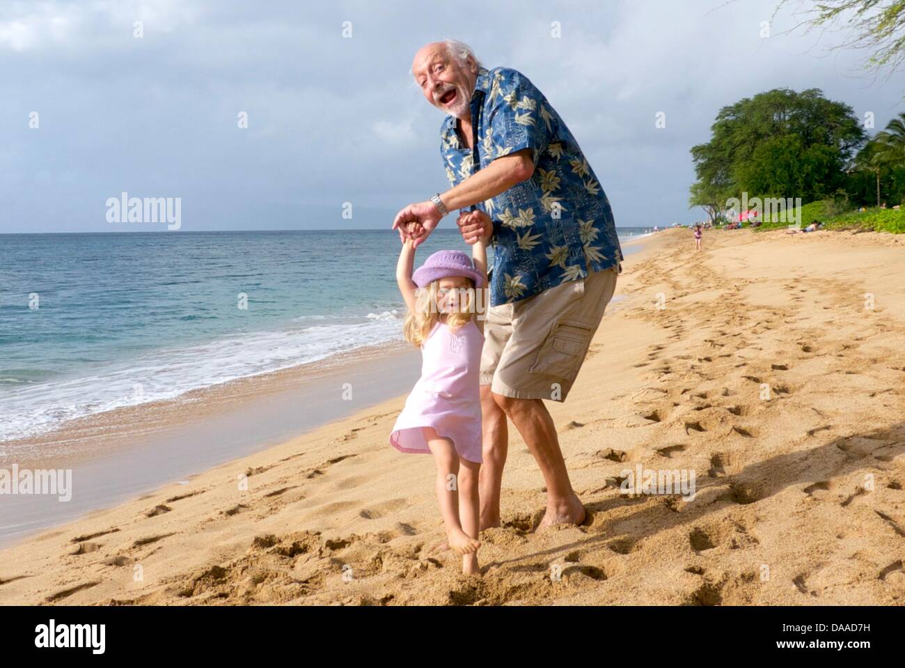 German comic Karl Dall plays with his granddaughter Nelina at the beach on the Hawaiian island of Maui, USA, 22 January 2011. On 01 February 2011, Mr Dall turns 70. Photo: Jovan Nenadic Stock Photo