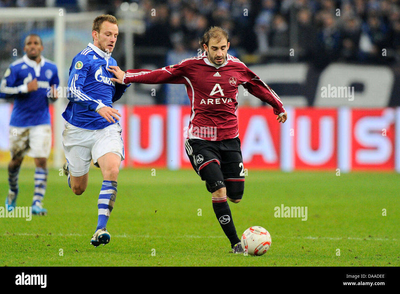 Schalke's Ivan Rakitic (L) and Nuremberg's Javier Pinola (L) vie for the ball during DFB Cup quarter-finals match FC Schalke 04 v 1.FC Nuremberg at Veltins Arena stadium in Gelsenkirchen, Germany, 25 January 2011. Schalke won the match with 3-2 after extra time. Photo: Revierfoto Stock Photo