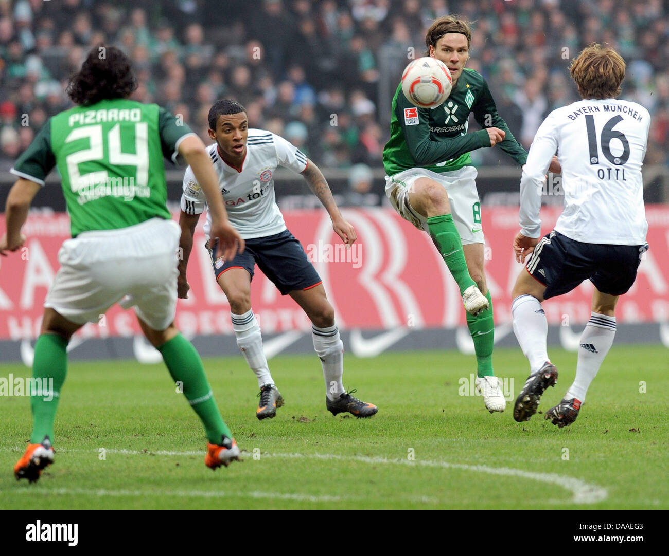 Bremen's players Claudio Pizarro (L) and Clemens Fritz (3rd from L) fight for the ball against Munich's Luis Gustavo and Andreas Ottl (R) during the Bundesliga soccer match between Werder Bremen and Bayern Munich in the Weser Stadion in Bremen, Germany, 29 January 2011. Photo: Ingo Wagner Stock Photo