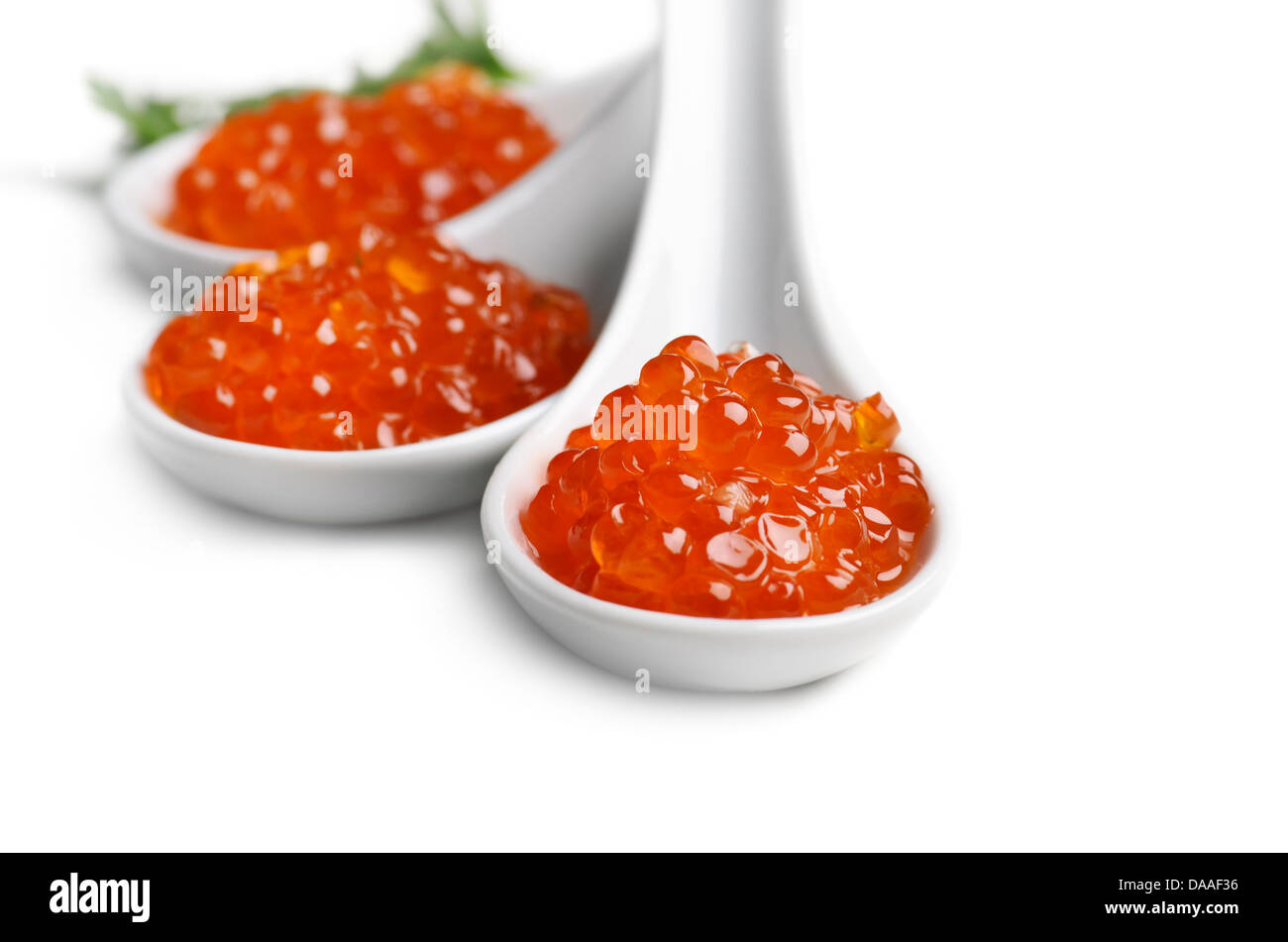 Caviar in white spoon isolated over white Stock Photo