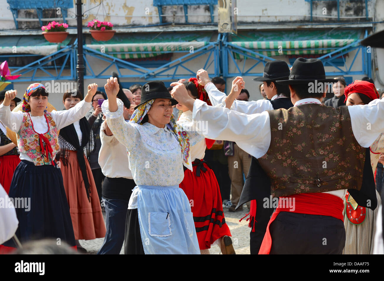 Dancers in traditional Portuguese dress take part in folk dancing at