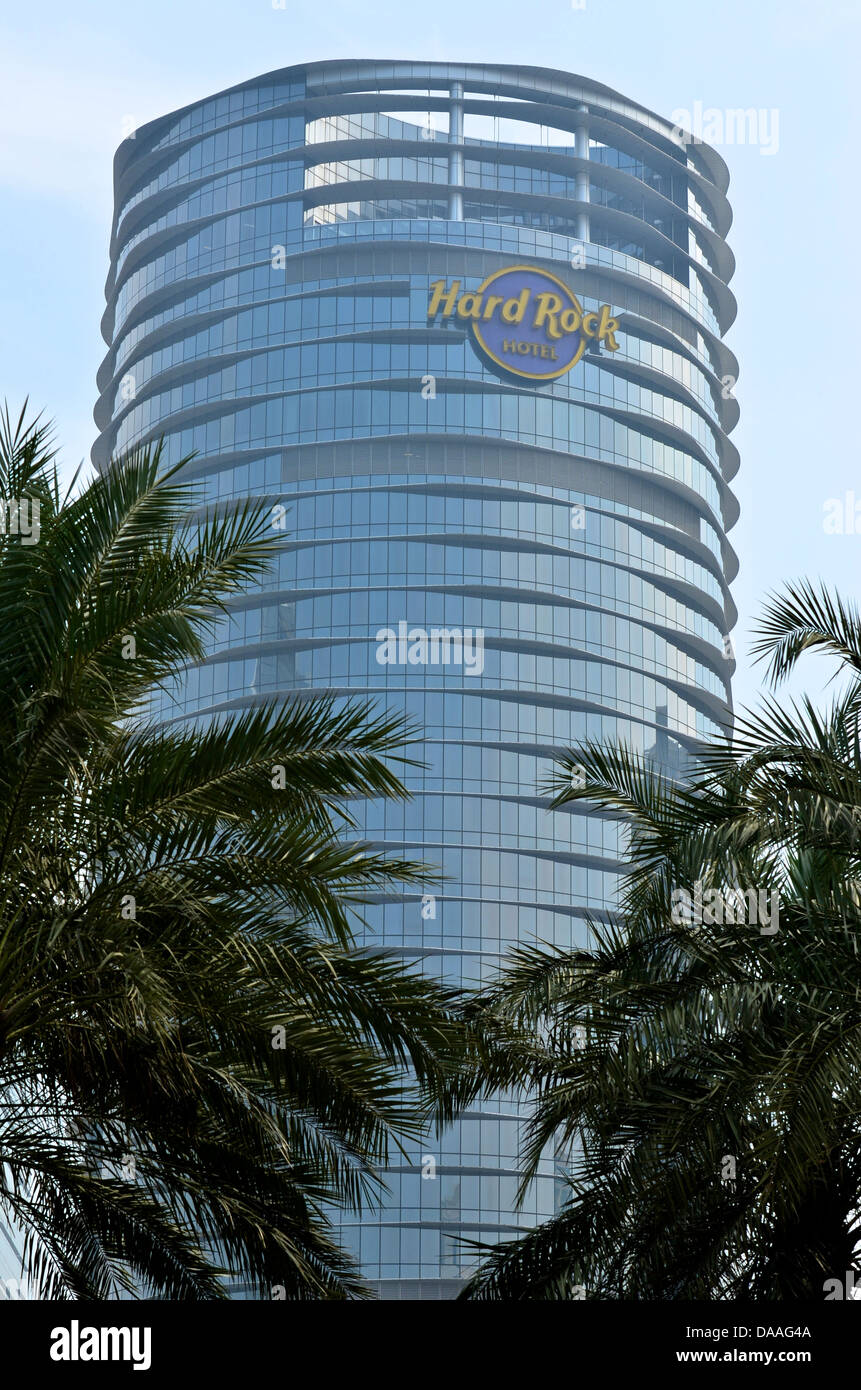 The high-rise tower of the Hard Rock Hotel viewed through the palm-trees on the Cotai Strip. Stock Photo