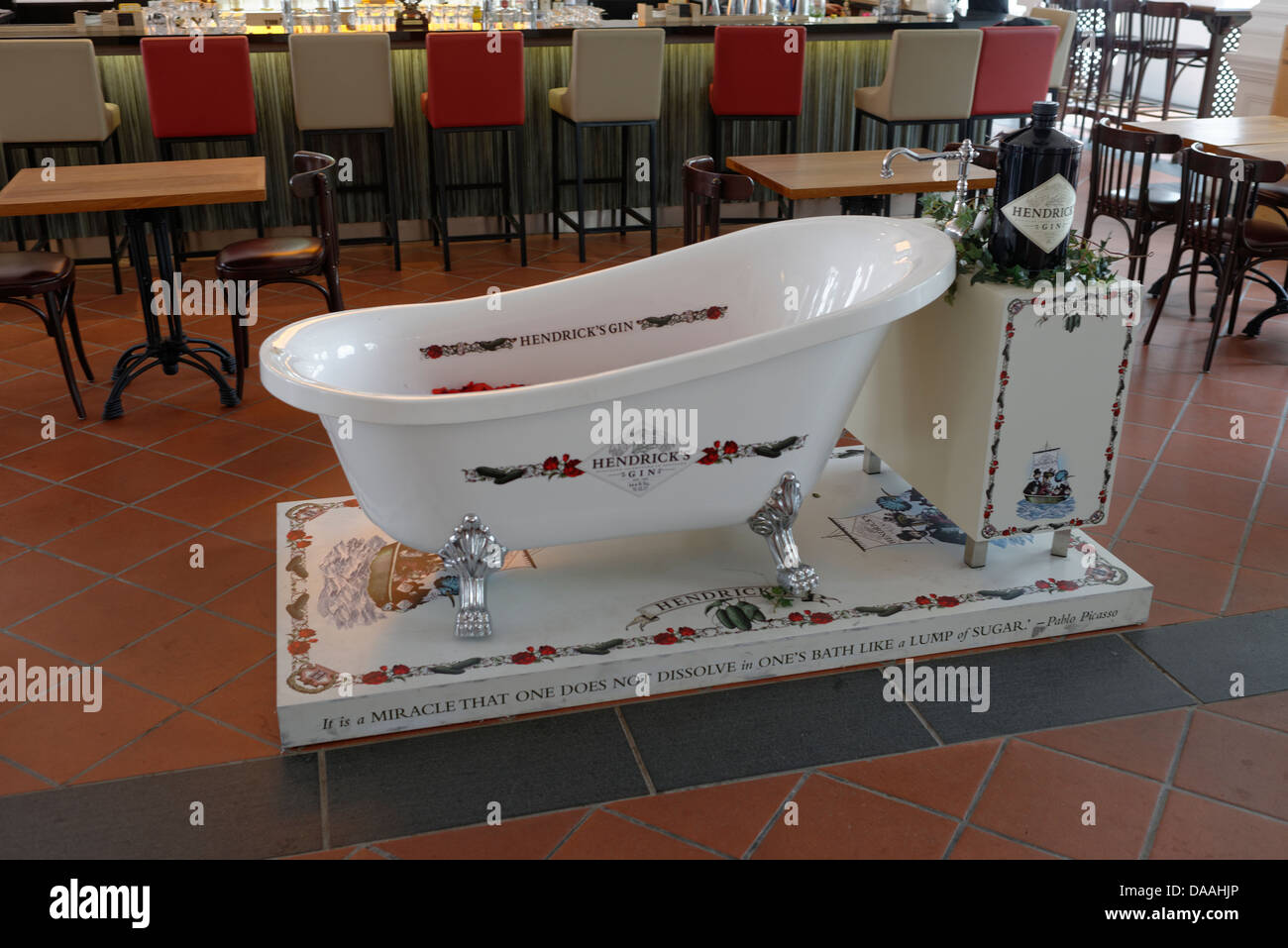Classic roll top bath with Hendricks Gin dispenser as tap in a Raffles bar, Singapore Stock Photo