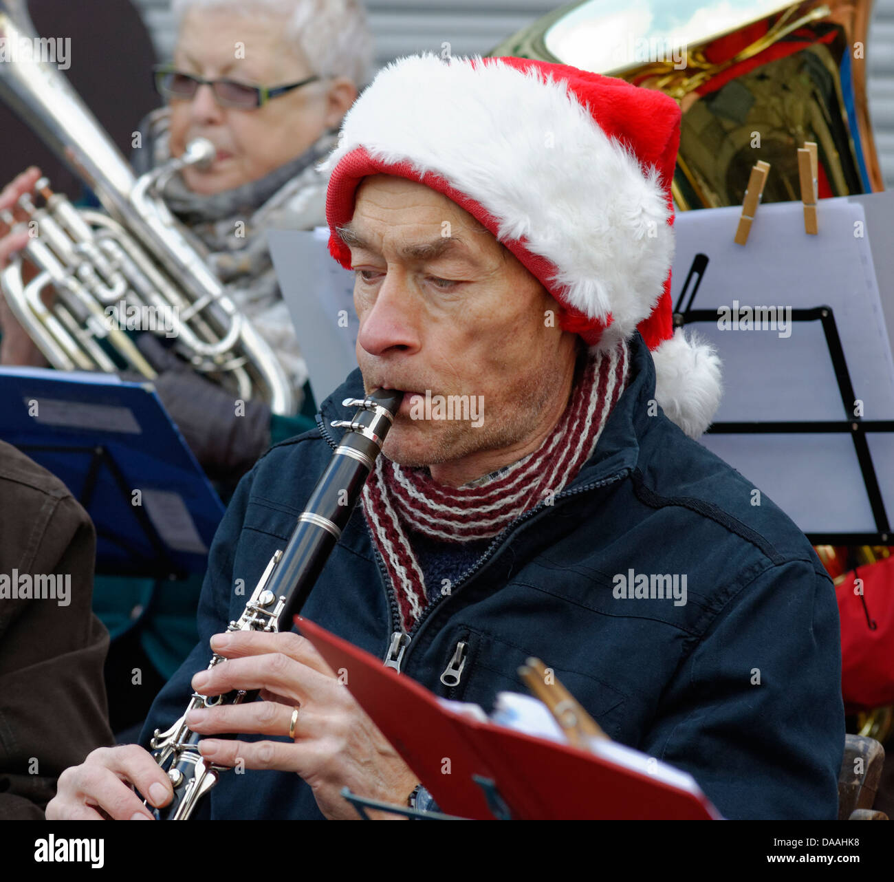 Flute playing musician playing in a santa hat in the Crown Road