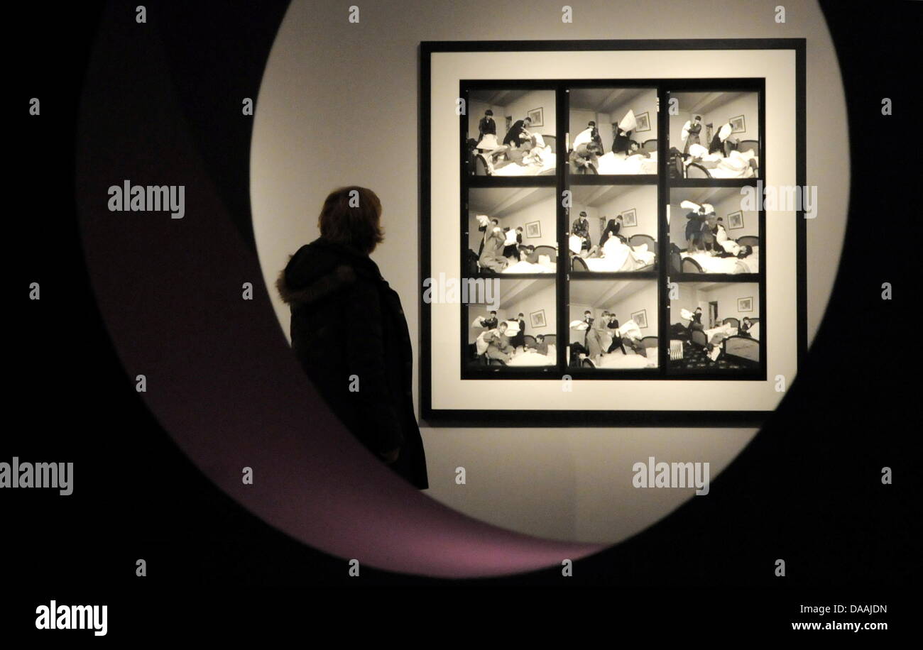 A Woman Eyes A Photography Of The Beatles Doing A Pillow Fight