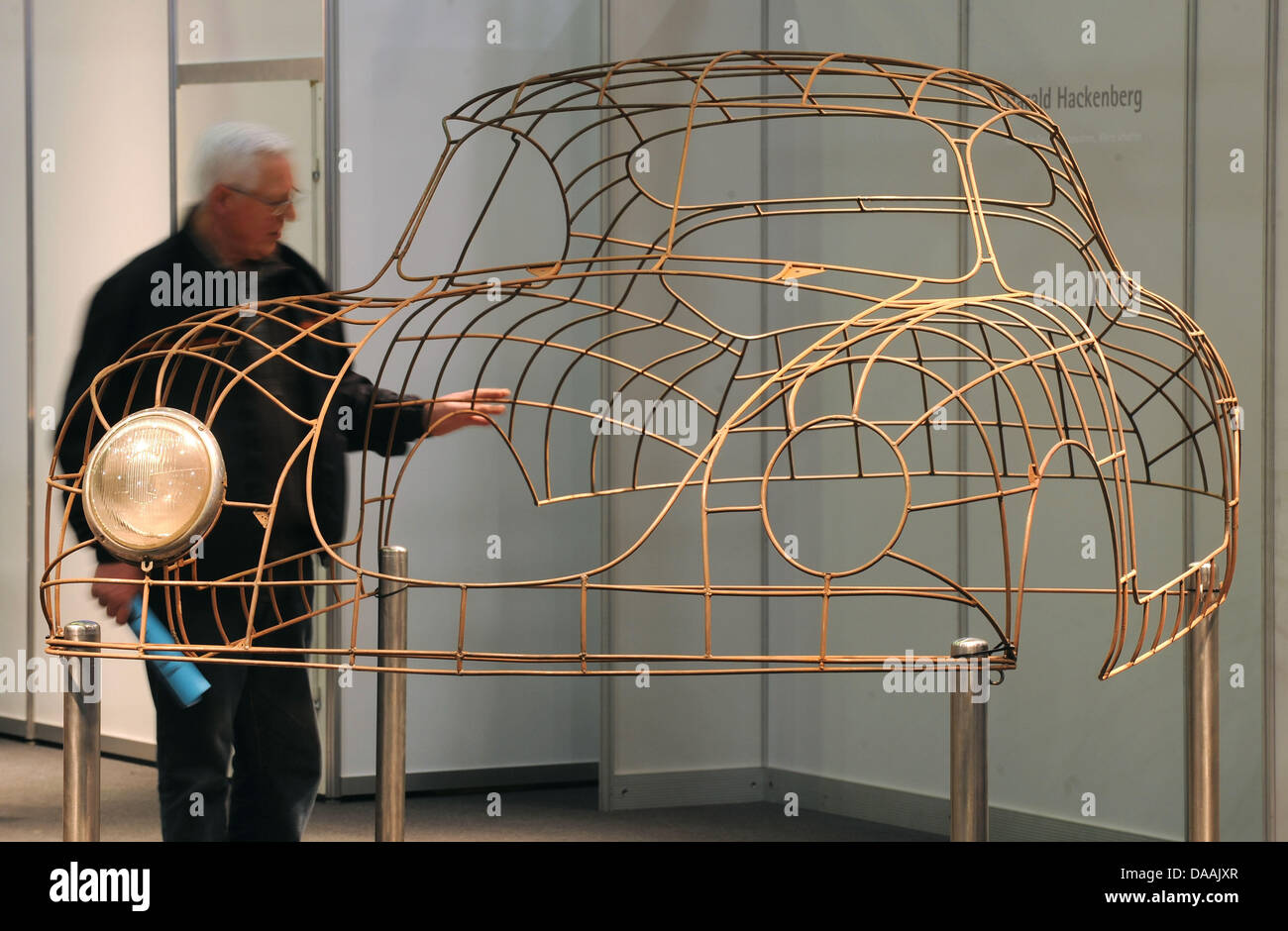 A visitor looks at the skeleton of a 356 Porsche at this year's 'Bremen Classic Motorshow' in Bremen, Germany, 04 February 2011. Around 550 exhibitors from 11 countries present highlight from automotive history from 04 until 06 February 2011, and more than 36,000 visitors are expected. Photo: INGO WAGNER Stock Photo