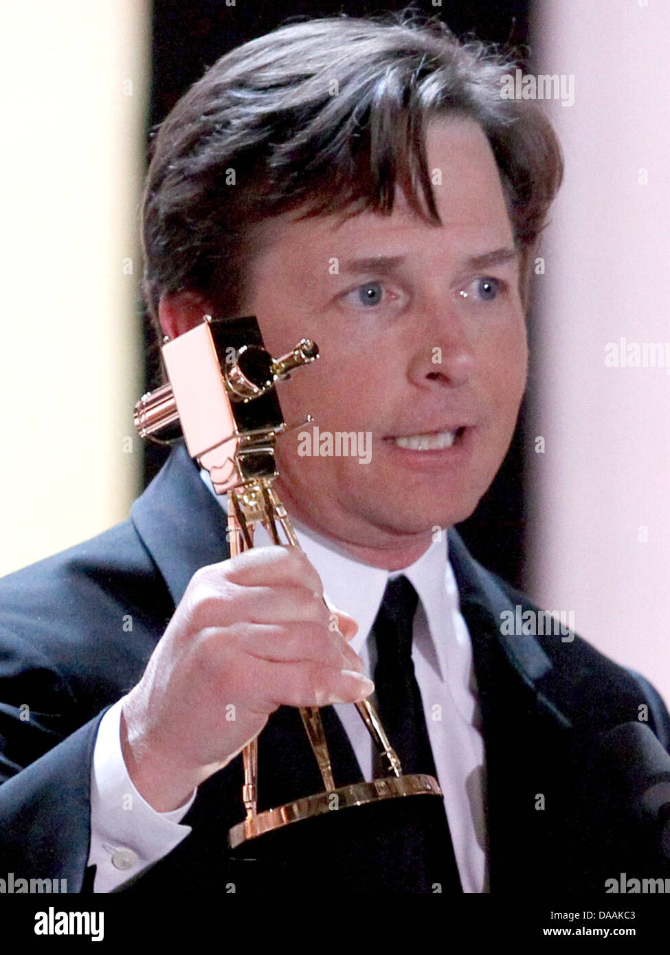 Canadian born actor Michael J. Fox holds his international lifetime achievement award during the 46th Golden Camera award ceremony in Berlin, Germany, 5 February 2011. The award honours the audience's favourites from film, television, sports and media. Photo: Tobias Schwarz dpa/lbn Stock Photo