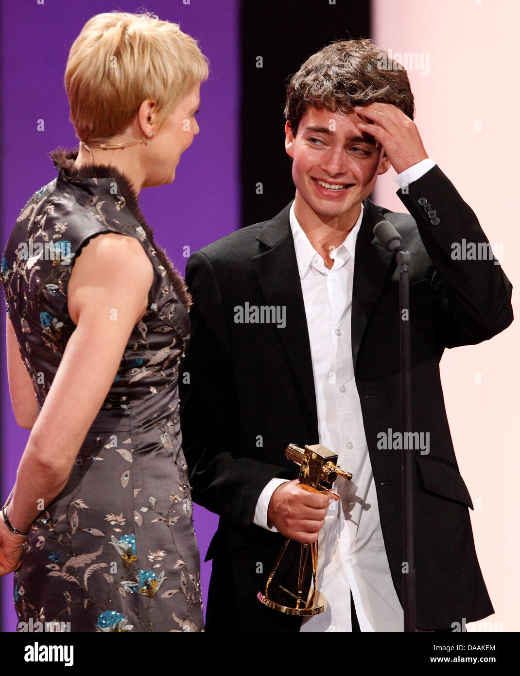 German actor Max Hegewald receives the award for best newcomer from comedian Cordula Stratmann during the 46th Golden Camera award ceremony in Berlin, Germany, 5 February 2011. The award honours the audience's favourites from film, television, sports and media. Photo: Tobias Schwarz dpa/lbn Stock Photo