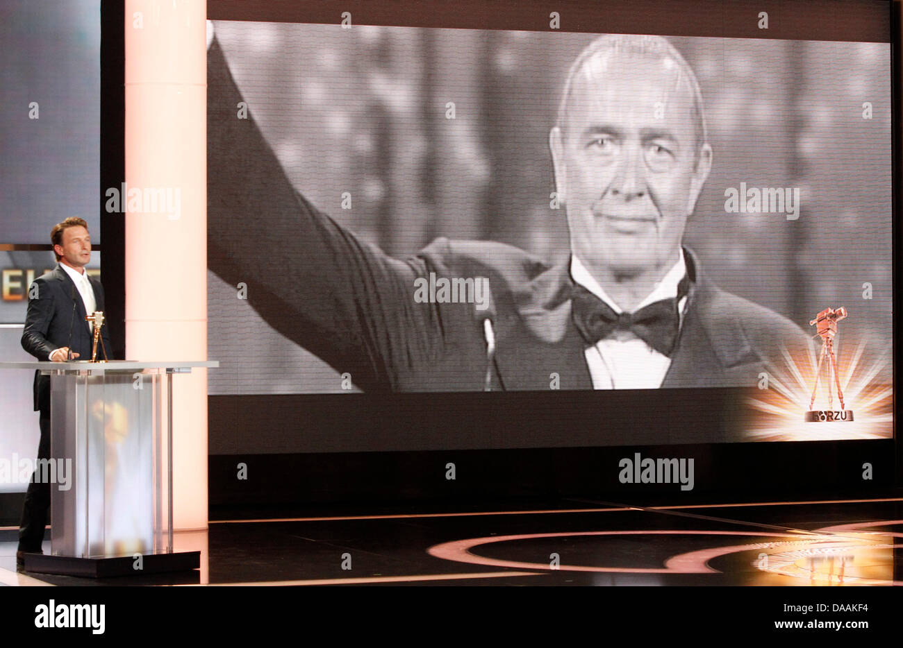 German actor Thomas Kretschmann appears on stage to accept an honorary award on behalf of Bernd Eichinger (pictured on screen) during the 46th Golden Camera award ceremony in Berlin, Germany, 5 February 2011. The award honours the audience's favourites from film, television, sports and media. Photo: Tobias Schwarz dpa/lbn Stock Photo
