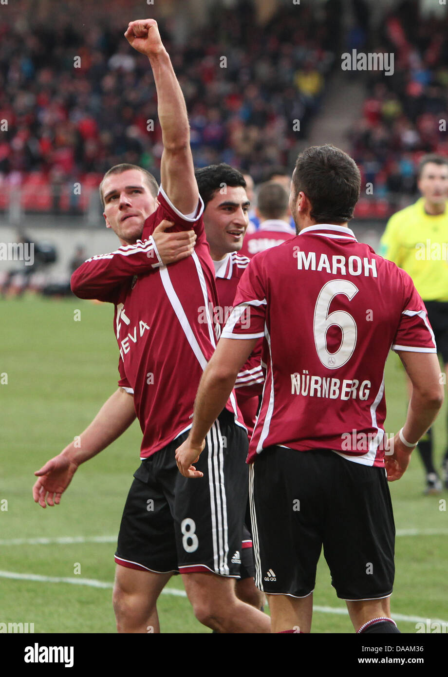 Nuremberg's Christian Eigler (L) celebrates together with his teammates Mehmet Ekici (C) and Dominic Maroh after scoring the 1-0 goal during the Bundesliga soccer match between 1st FC Nuremberg and Bayer 04 Leverkusen at the easyCredit Stadion in Nuremberg, Germany, 5 February 2011. Photo: Daniel Karmann Stock Photo