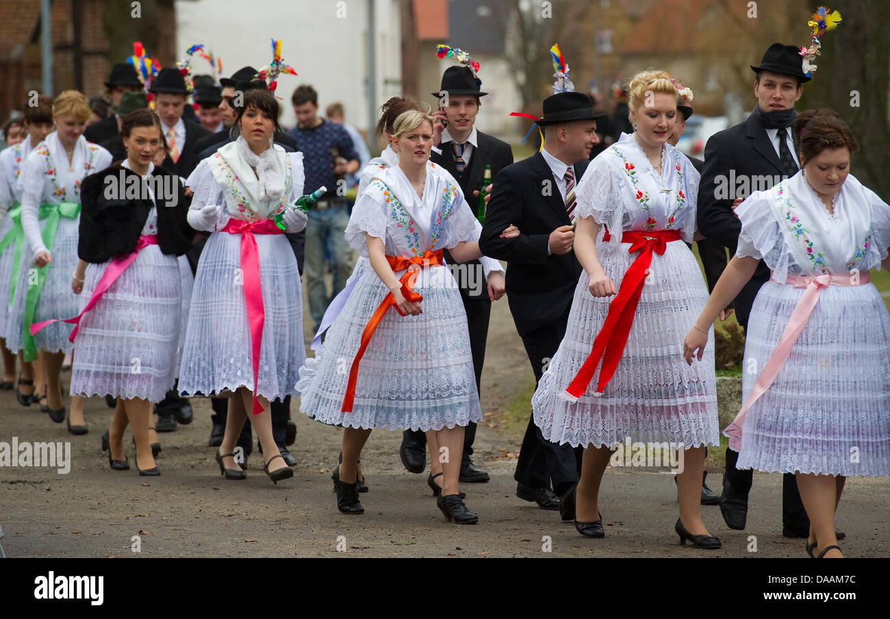 A crowd of men and women dressed in traditional Sorbian costumes ...
