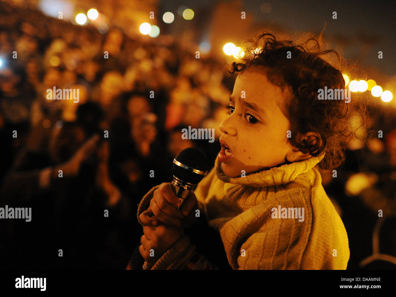 A small child addresses the crowd at Tahrir Square in Cairo, Egypt, 07 February 2011. It is the 14th day of continuous protest against Egyptian President Mubarak. Photo: HANNIBAL HANSCHKE Stock Photo