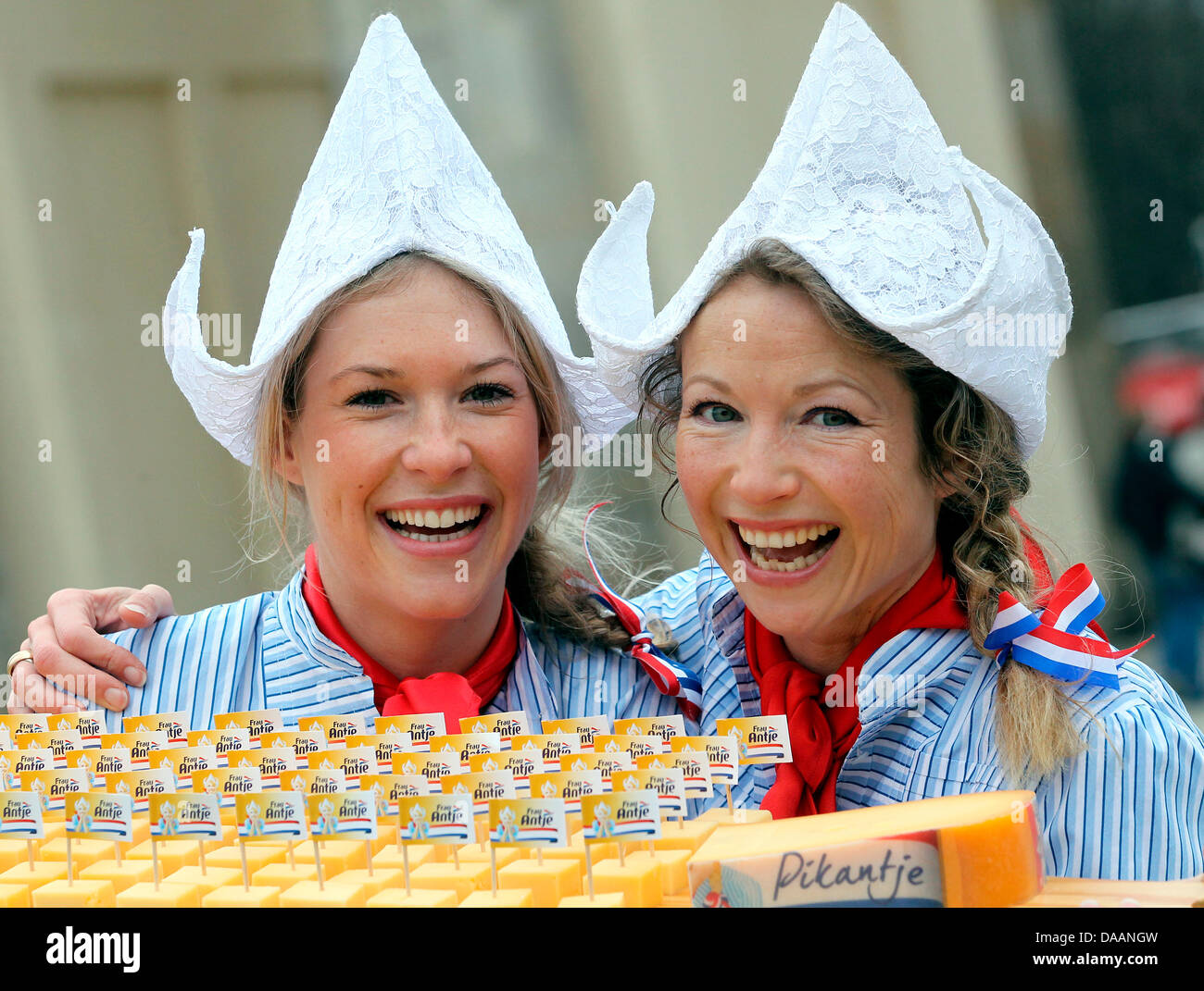 On the occasion of the world's biggest fair for food, agriculture and horticulture, the International Green Week Berlin, Mandy Smits (L) offers fresh Gouda with her predecessor Madeleen Driessen at the Brandenburg Gate in Berlin, Germany, 20 January 2011. The two women are impersonators of the advertising character 'Ms Antje', representing Dutch dairy. The Green Week last from 21 u Stock Photo