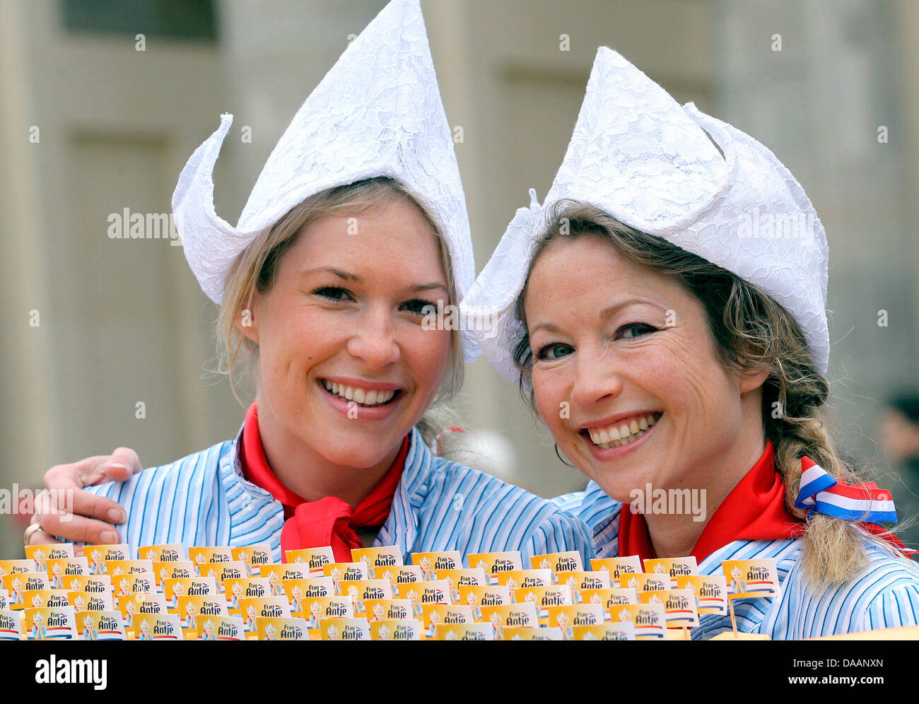 On the occasion of the world's biggest fair for food, agriculture and hortriculture, the International Green Week Berlin, Mandy Smits (L) presents fresh Gouda with her predecessor Madeleen Driessen at the Brandenburg Gate in Berlin, Germany, 20 January 2011. The two women are impersonators of the advertising character 'Ms Antje', representing Dutch dairy. The Green Week last from 2 Stock Photo
