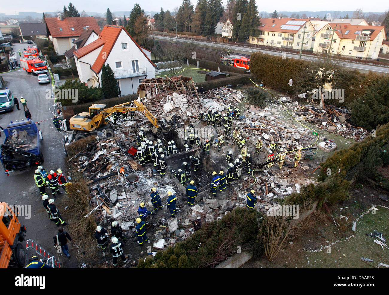 Firemen examine the site of an explosion in Germering, Germany, 20 January 2010. Shortly after a residential house exploded, a woman's body was recovered from the debris. At least two people died in the explosion. Photo: Michaela Rehle Stock Photo