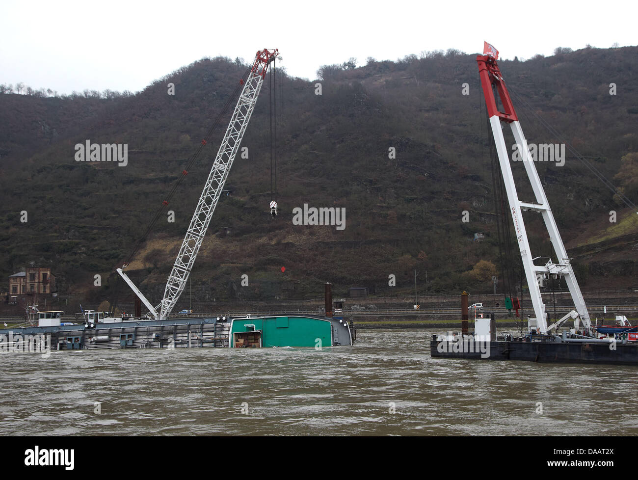 A second ship with crane takes it's position on the rhine at the accident site nearby St Goarshausen, Germany, 23 January 2011. Here, a tanker with sulphuric acid has sunk. The Havarist will first be secured with more steel cables. The complete salvage will take about 3 weeks. Photo: Thomas Frey Stock Photo