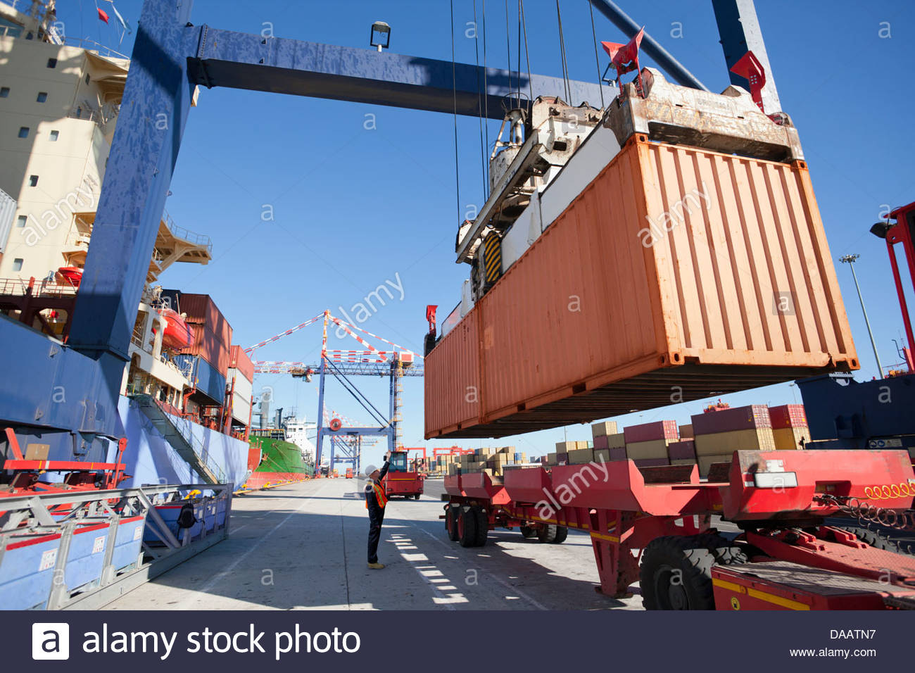 Crane unloading container ship at commercial dock Stock Photo, Royalty ...