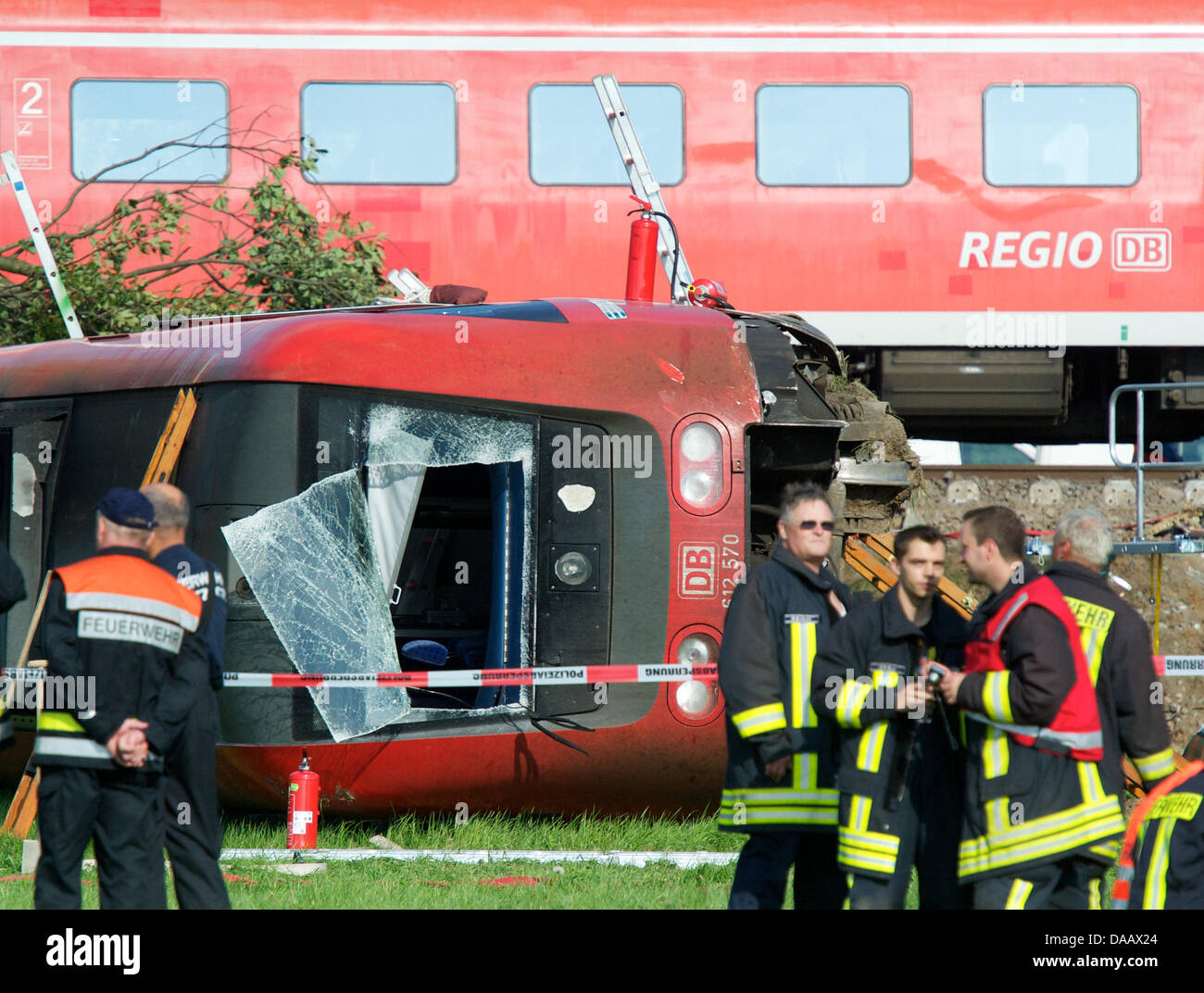 Rescue teams stand next to a demlished train after an accident in Lauterbach, Germany, 20 September 2011. A regional express crashed into a car around one p.m. and the first three coaches derailed. Numerous people were injured during the accident. Peter Endig Stock Photo