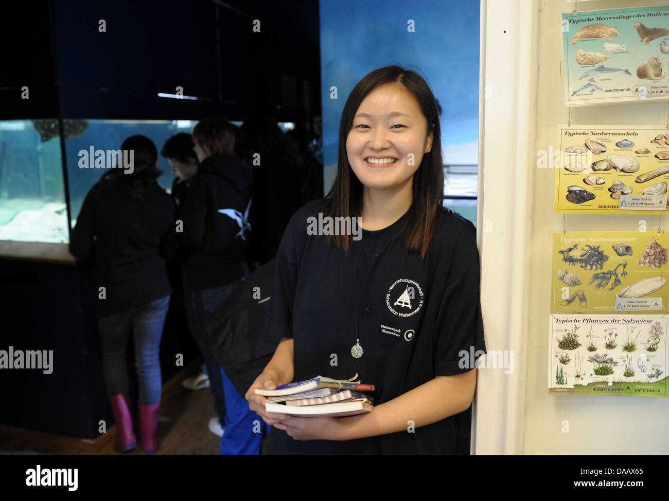 South Korean student, Dschi in Ha, smiles as she stands next to a group of visitors at the Wadden Sea Conservation Station in Hoernum on the island of Sylt, Germany, 15 September 2011. The 22-year old German Studies student  is working a volonteer at the station for two months. Photo: Christian Charisius dpa/lno Stock Photo