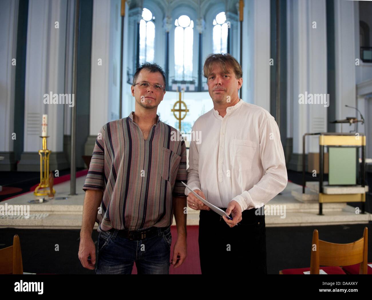 Priest Christoph Schmidt (L) and Norbert Reichers pose before the beginning of a religious service in the Evangelical St. Thomas Church in Berlin, Germany, 21 September 2011. The archbichopric criticized that St. Thomas parish is letting both homosexual priests, who have been suspended, give e relgious service in their rooms. Photo: JOERG CARSTENSEN Stock Photo