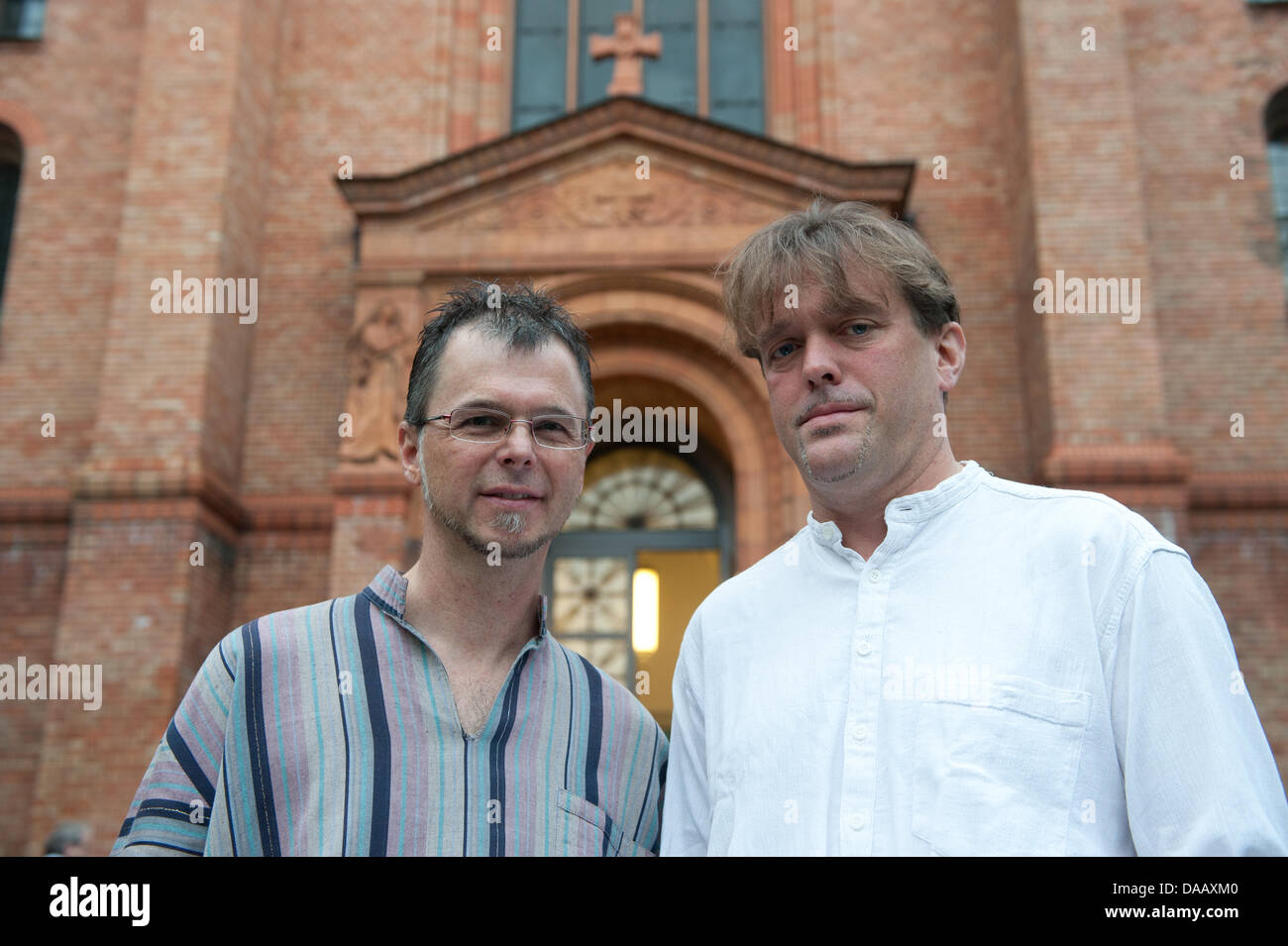 Priest Christoph Schmidt (L) and Norbert Reichers pose before the beginning of a religious service in front of the Evangelical St. Thomas Church in Berlin, Germany, 21 September 2011. The archbichopric criticized that St. Thomas parish is letting both homosexual priests, who have been suspended, give e relgious service in their rooms. Photo: JOERG CARSTENSEN Stock Photo