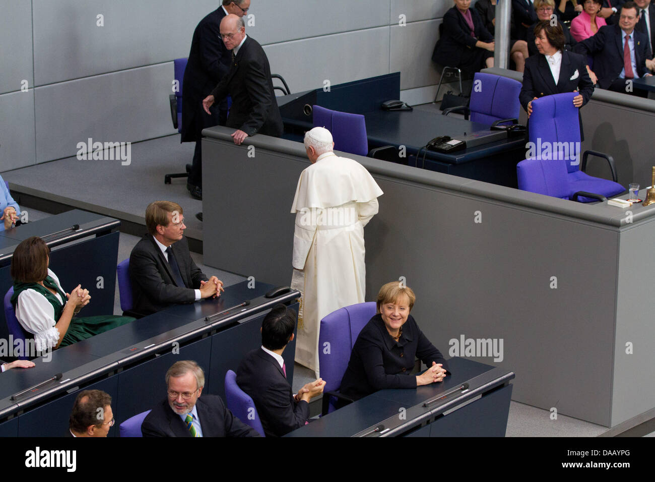 Pope Benedict XVI is being helped by President of Parliament Norbert Lammert after he took the wrong way to the speakers podium to deliver his speech in the Bundestag, Germany's parliament, in Berlin, Germany, 22 September, 2011. The head of the Roman Catholic Church is visiting Germany from 22-25 September 2011. At left is German Chancellor Angela Merkel. Foto: Herbert Knosowski d Stock Photo