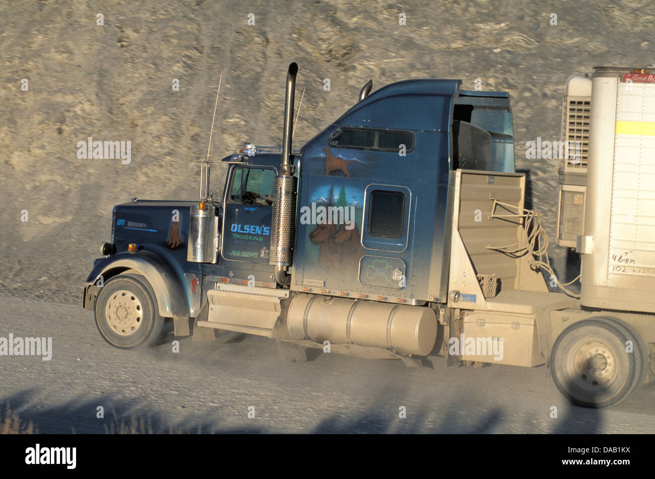Semi, Truck, Olsen's Trucking, Painting, dogs, moving, vehicle, sunset, dirt road, big, truck, rough, road, Atigun Pass, Dalton Stock Photo